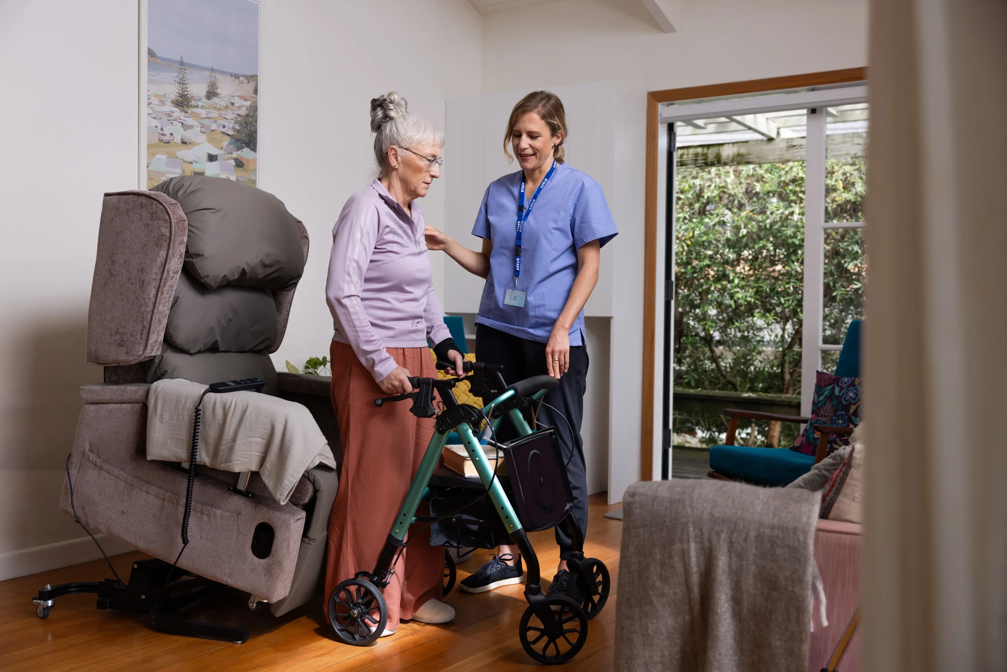 A senior woman tries a walker in her living room.