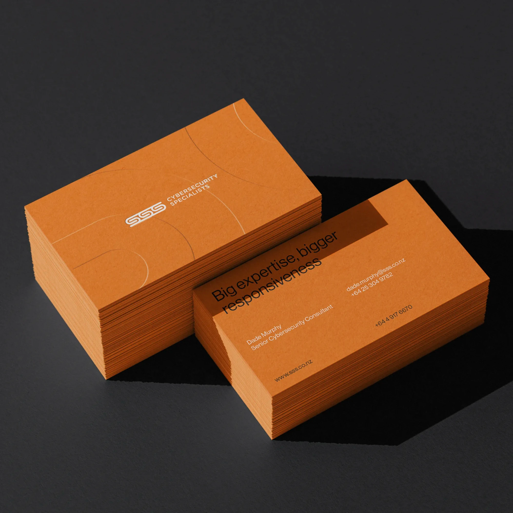 A stack of business cards show off subtle debossing detail