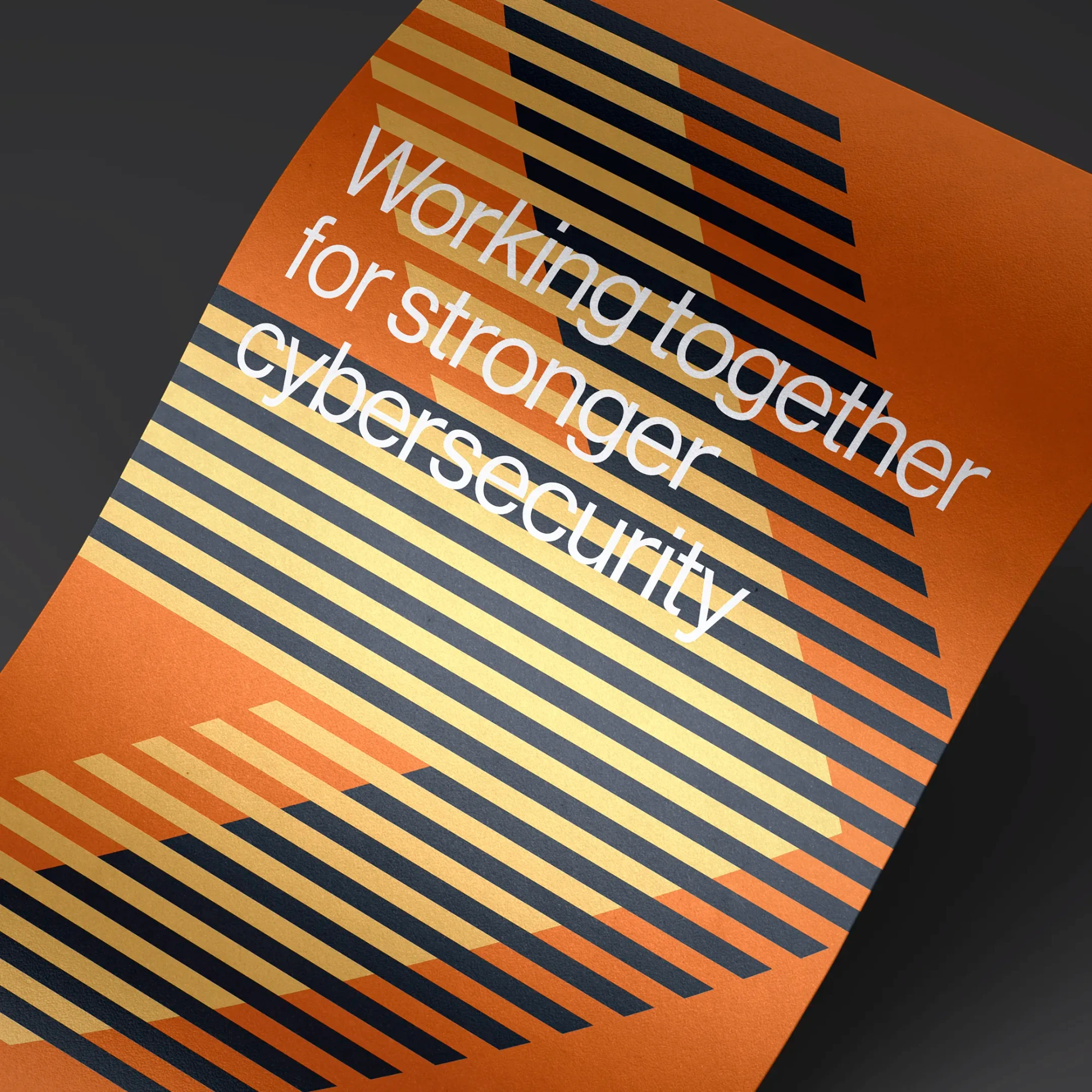 Close up detail of a graphic poster in burnt orange, featuring a large graphic arrow and text