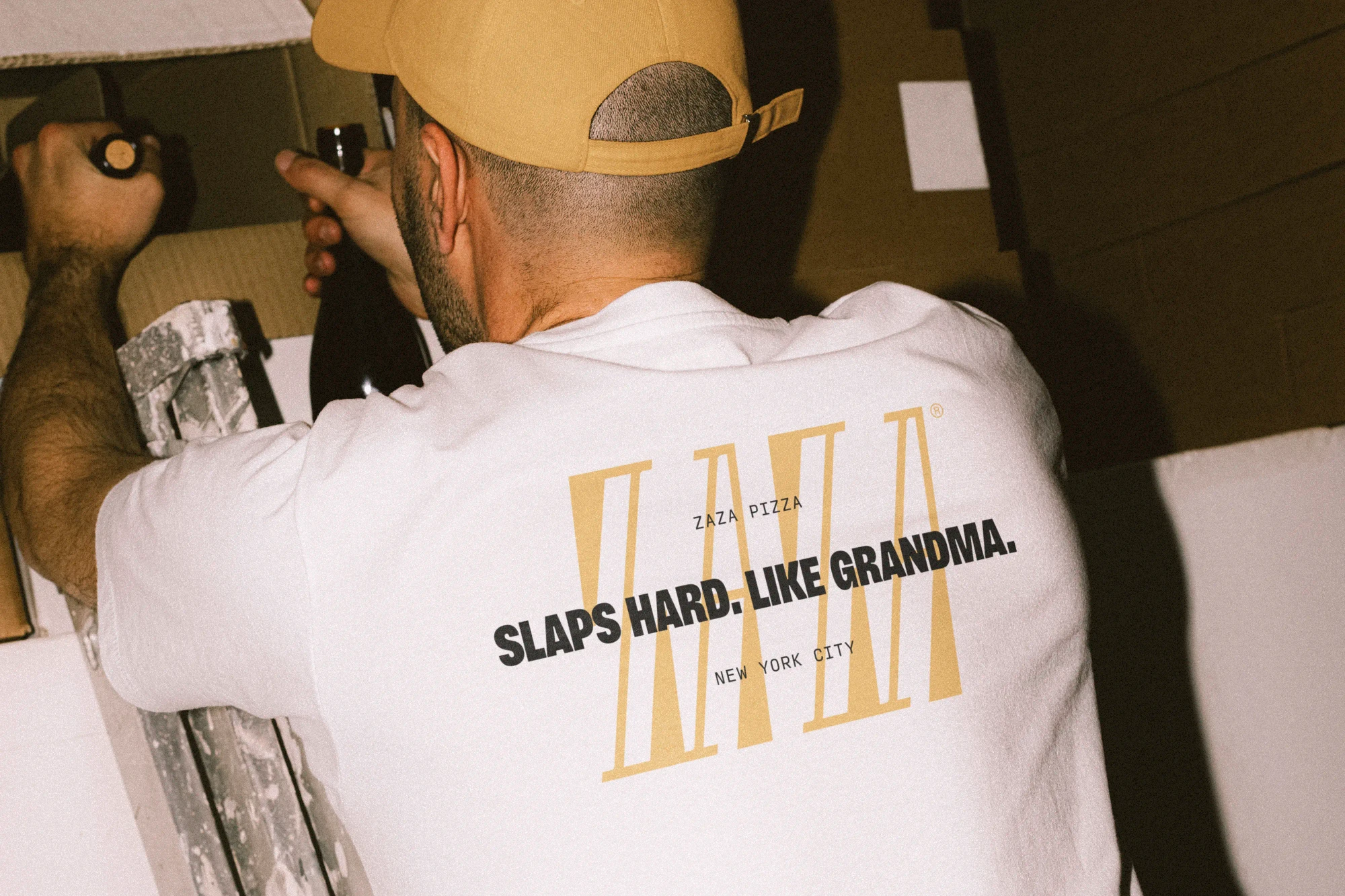 An employee wears a t-shirt that says 'Slaps hard. Like grandma.'