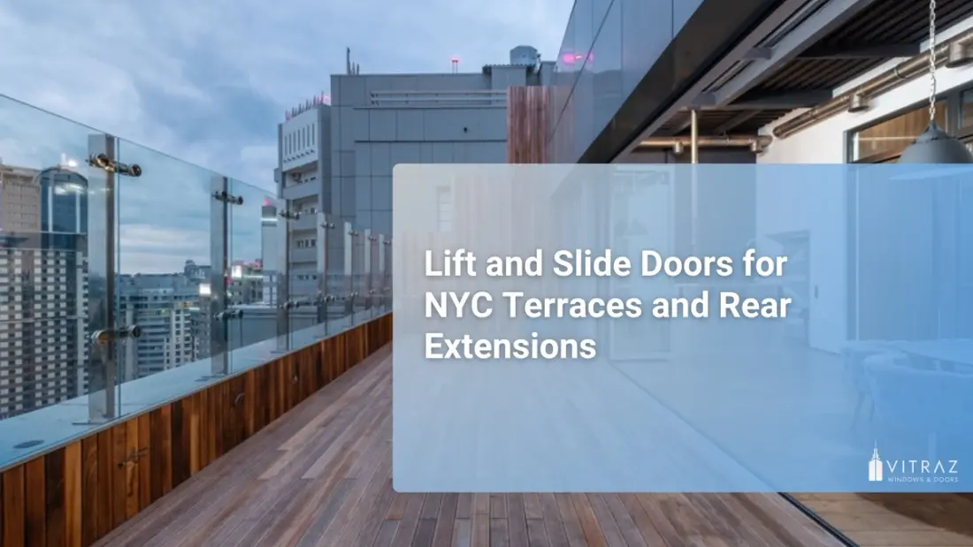 Urban rooftop terrace with wooden decking and glass railings overlooking city high-rises, with large glass sliding doors opening from an interior dining area onto the terrace at dusk