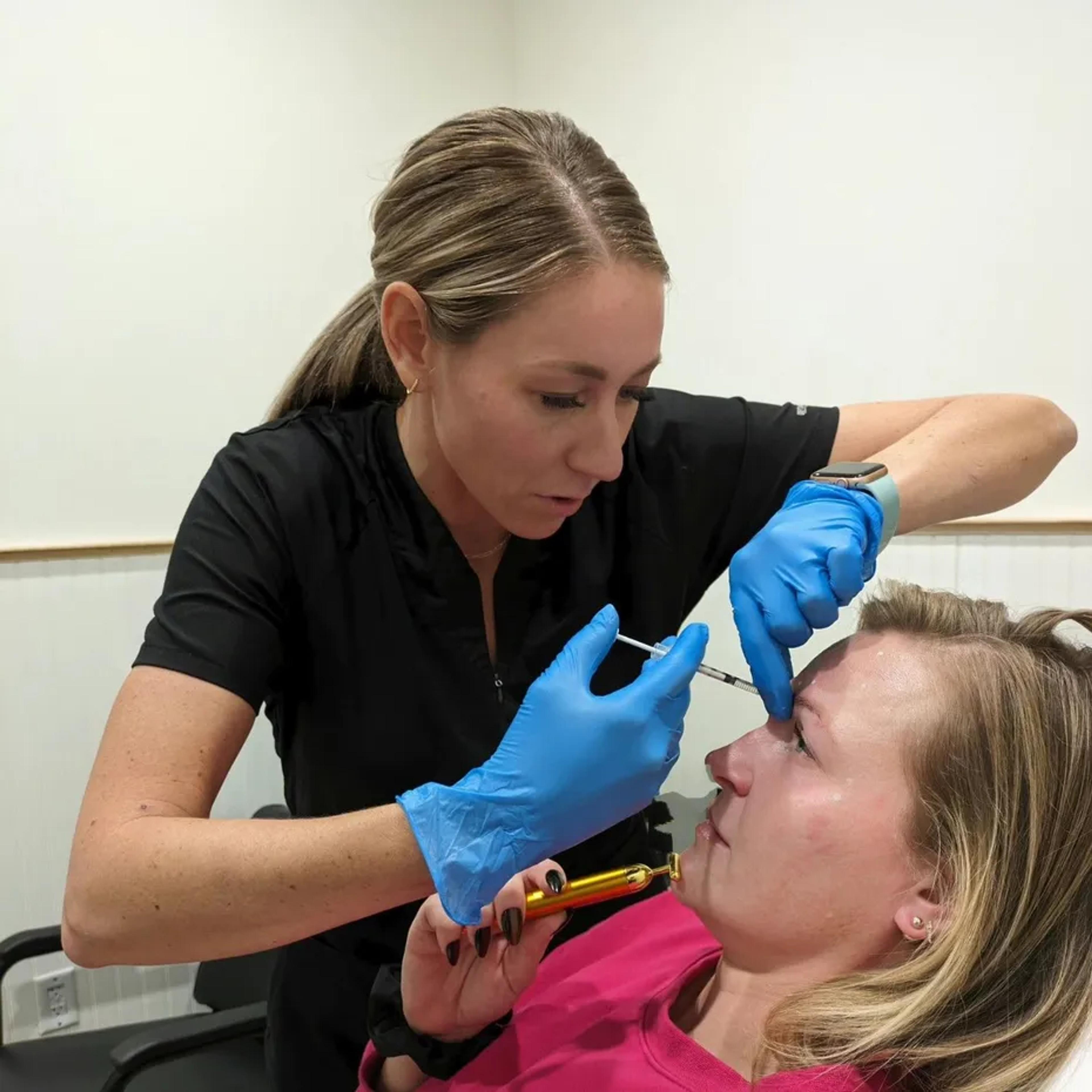 A nurse injector performing a cosmetic treatment