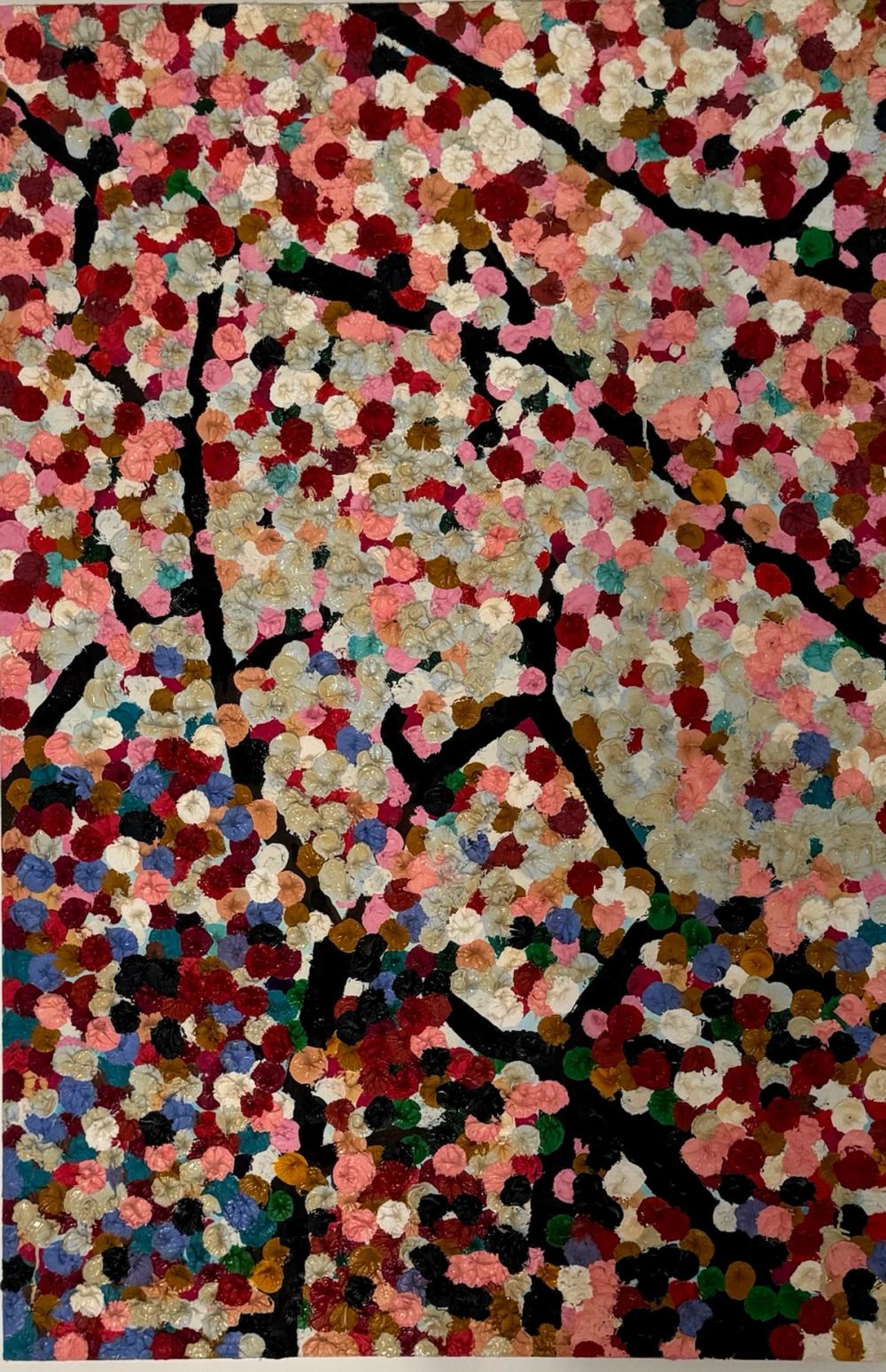Blossom tree painted in thick dabs of white, pink, crimson, ochre and blue over black branches