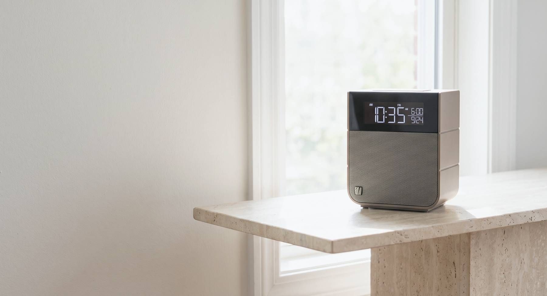 A Soundfreaq Sound Rise II on a stone plinth by a window in daylight