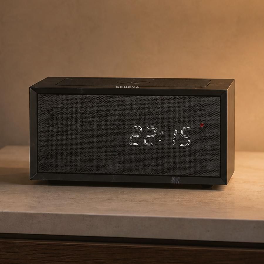 A Geneva Time digital in black on a limestone nightstand