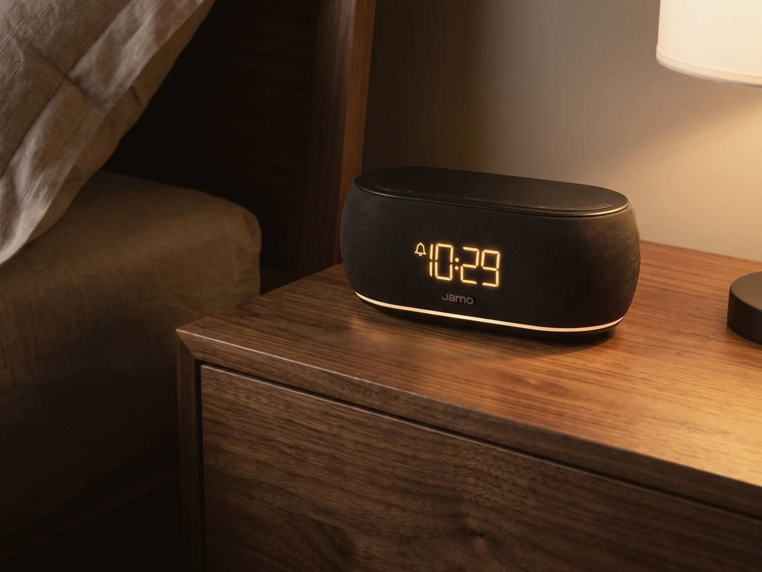 A Jamo HYG Reflect on a walnut nightstand at night
