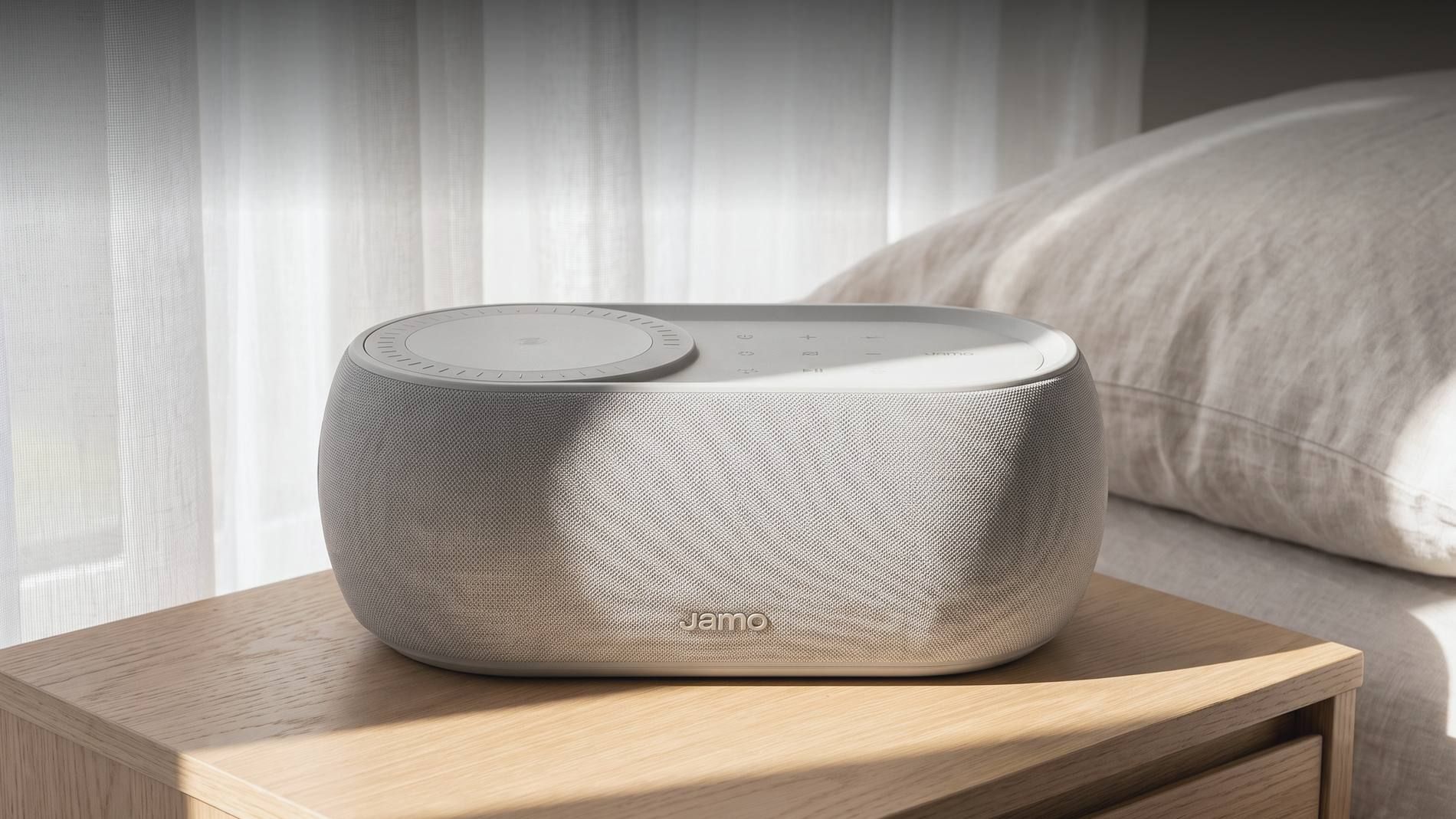 A Jamo HYG Reflect in light grey textile on a bedside table in daylight