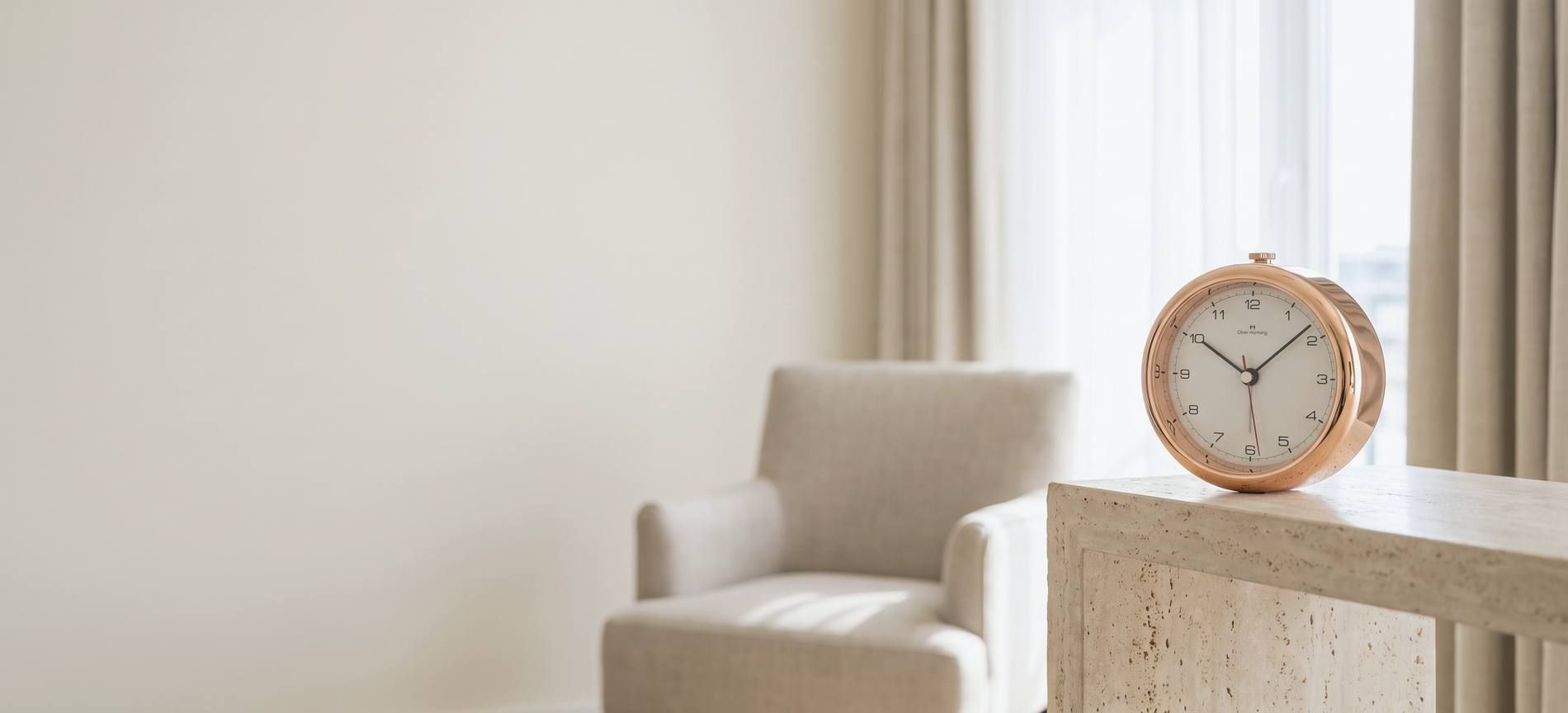 An Oliver Hemming Desire clock on a console in a daylit sitting room