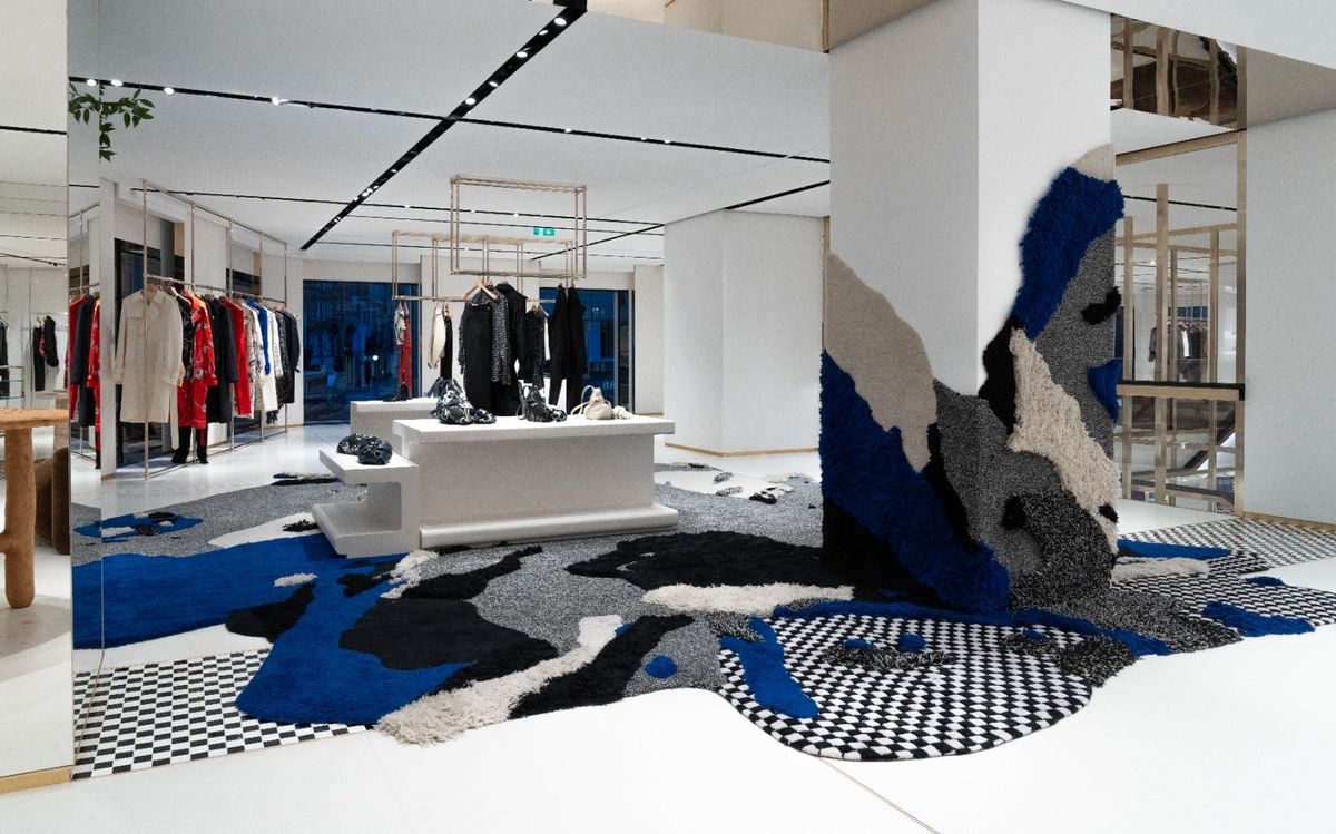 Store interior with checkerboard and blue rug