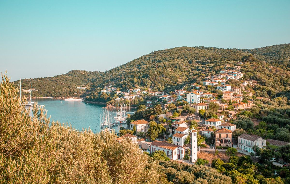 A small village in Ithaca, Greece surrounded by mountains and the sea at its feet.