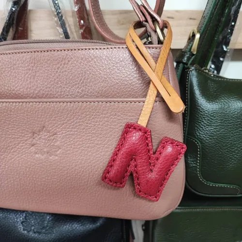 ที่ห้อยกระเป๋า N หนังแท้สีน้ำตาลเข้ม แขวนอยู่บนหูกระเป๋าถือของผู้หญิง - 01