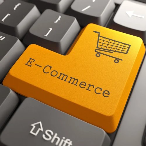 ภาพคีย์บอร์ดคอมพิวเตอร์ เน้นที่ปุ่ม Enter สีส้ม มีคำว่า E-Commerce และไอคอนรูปรถเข็นสินค้า