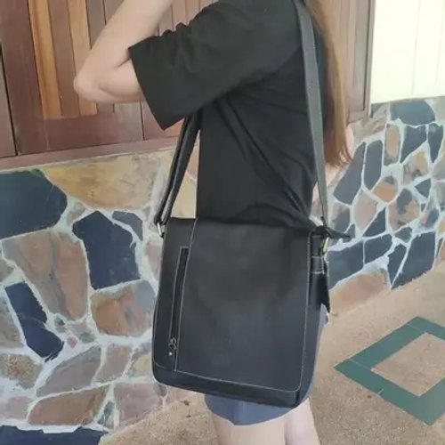 ผู้หญิงใช้กระเป๋าสะพายข้างสีดำที่เน้นความทนทานและใช้งานง่าย