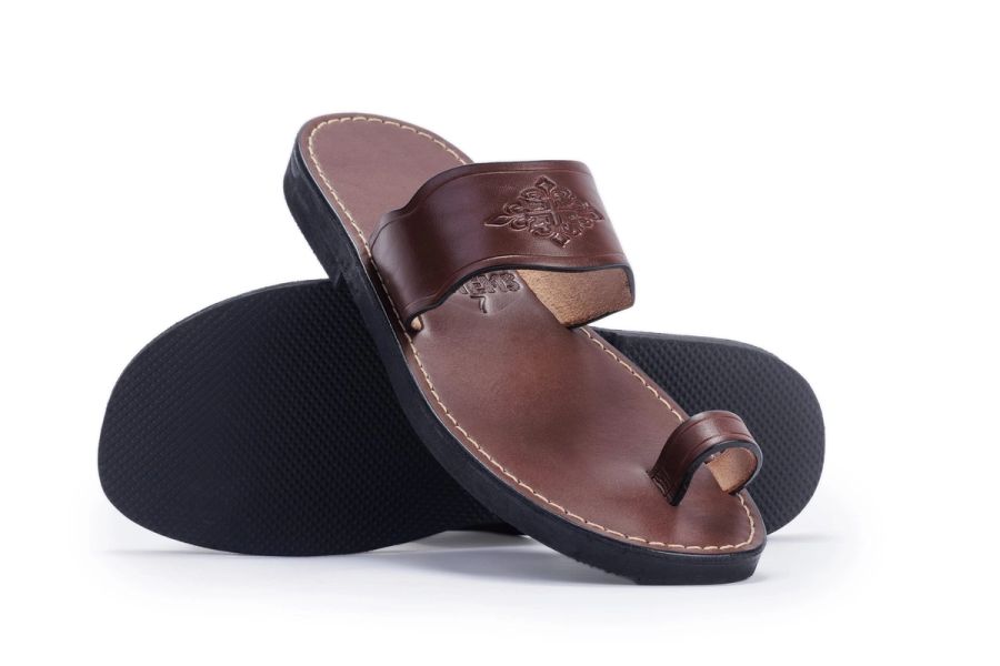 Brown leather toe-loop sandals with an embossed strap, photographed on a white background at Studio 039, Sea Park.