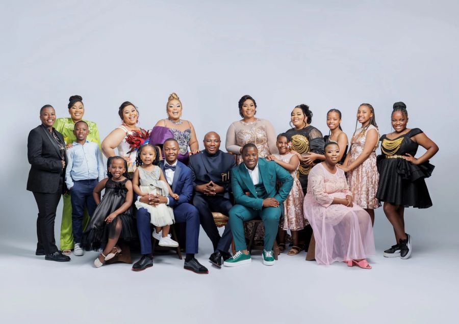 Large extended family in formal and celebratory outfits, posed together in the studio at Studio 039, Sea Park.