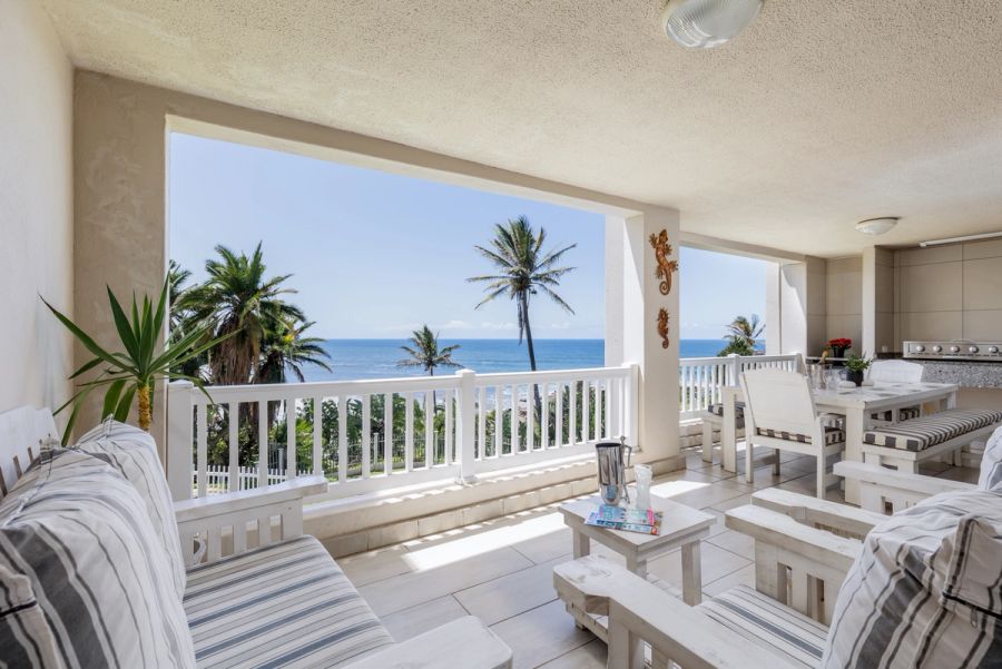 Covered veranda with outdoor seating overlooking the Indian Ocean at Laguna in Uvongo.
