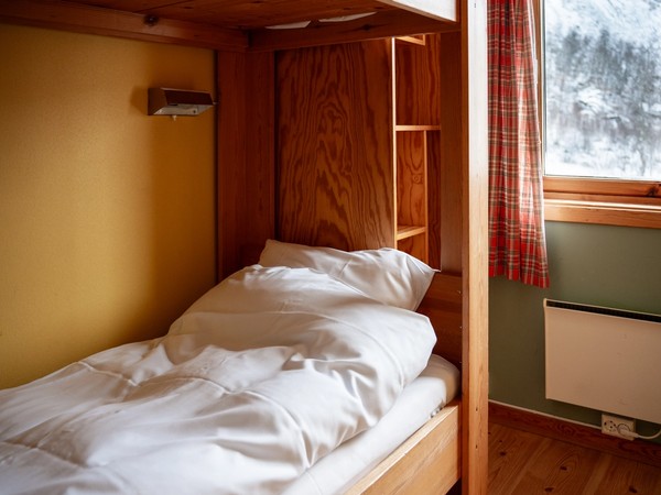 A warm private bunk room with exposed timber at Voss Mountain Lodge.