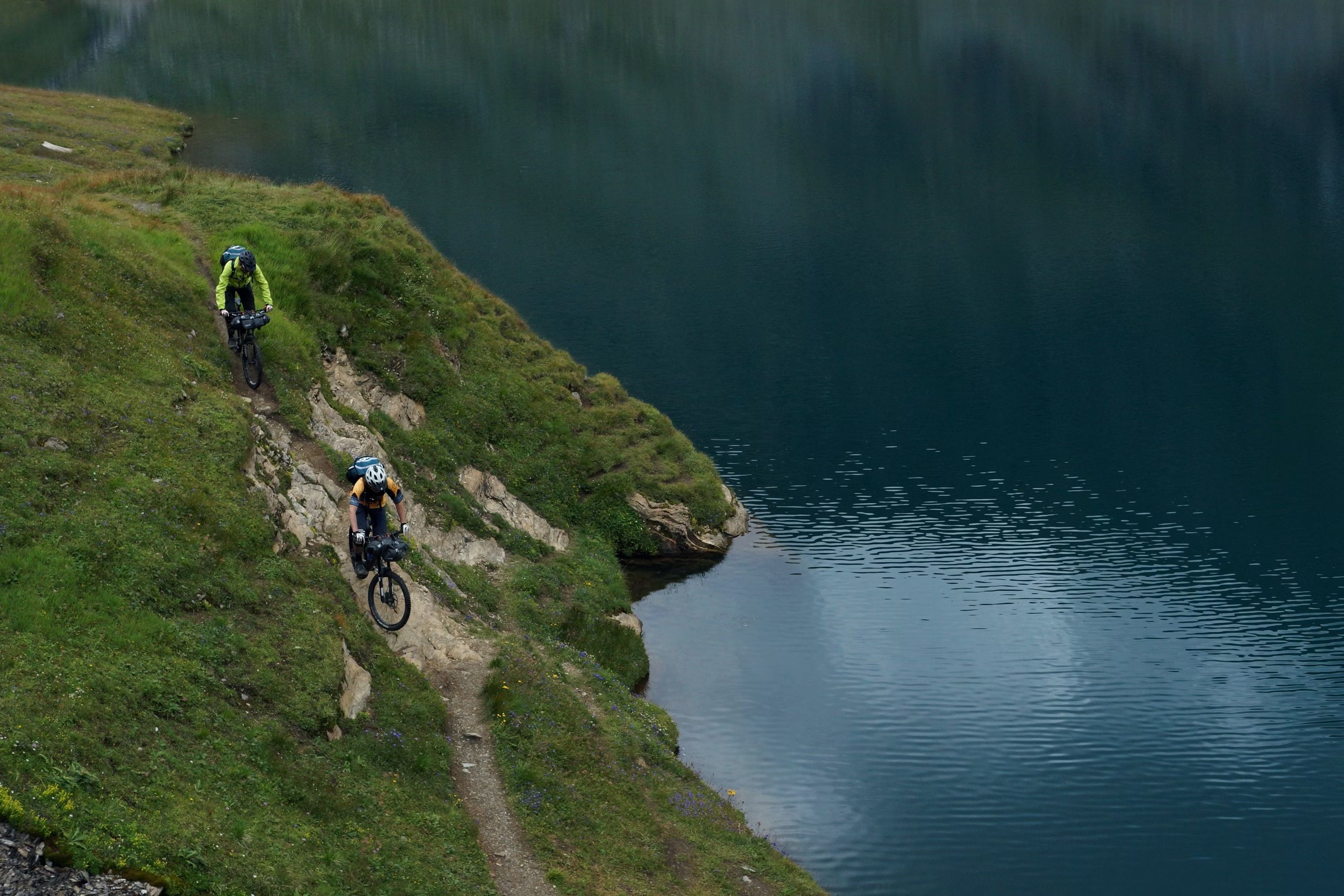 Mountain bikers riding along a lake in Voss Norway
