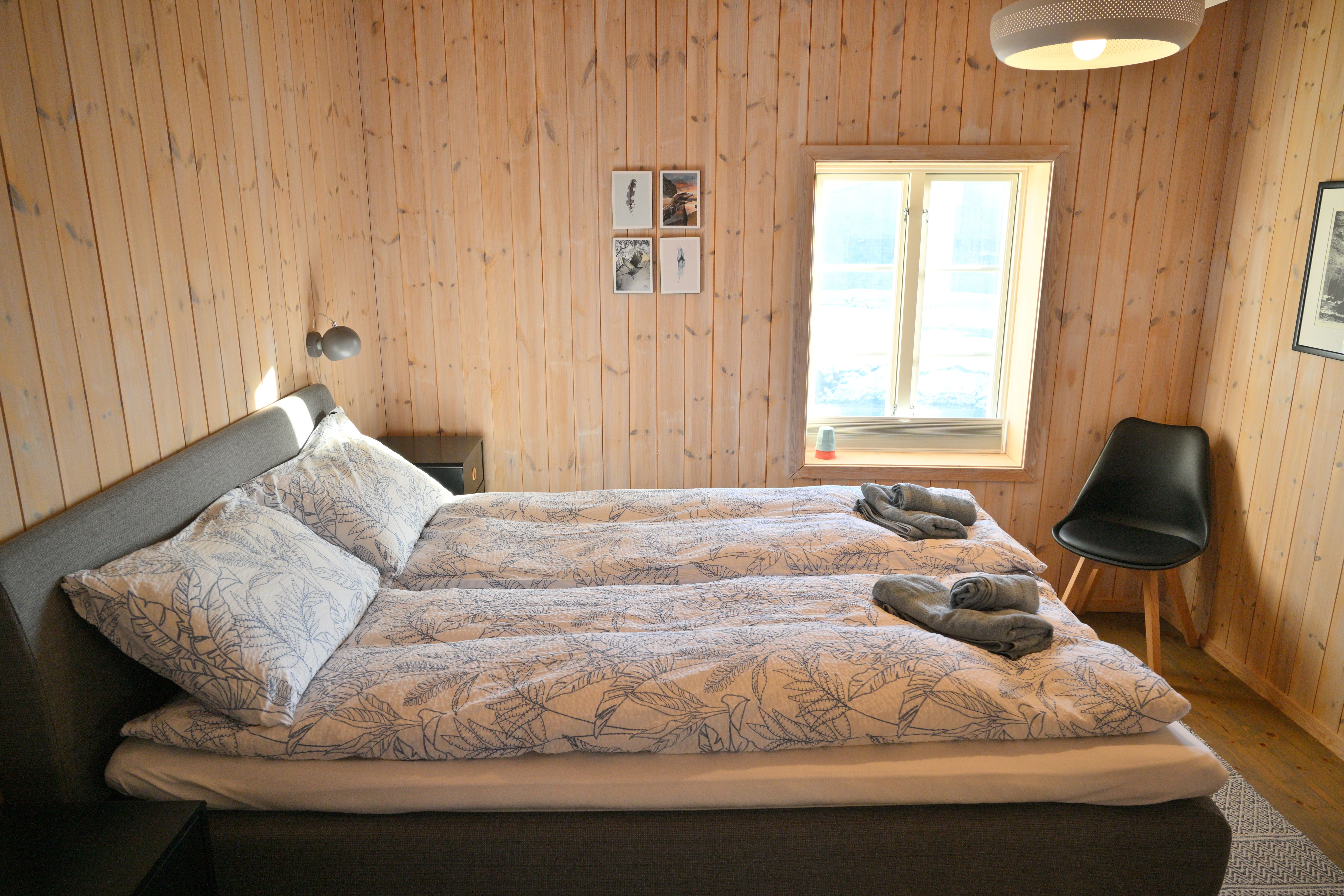 A cosy private bedroom with an all-wood interior at Lofoten Pier Lodge.
