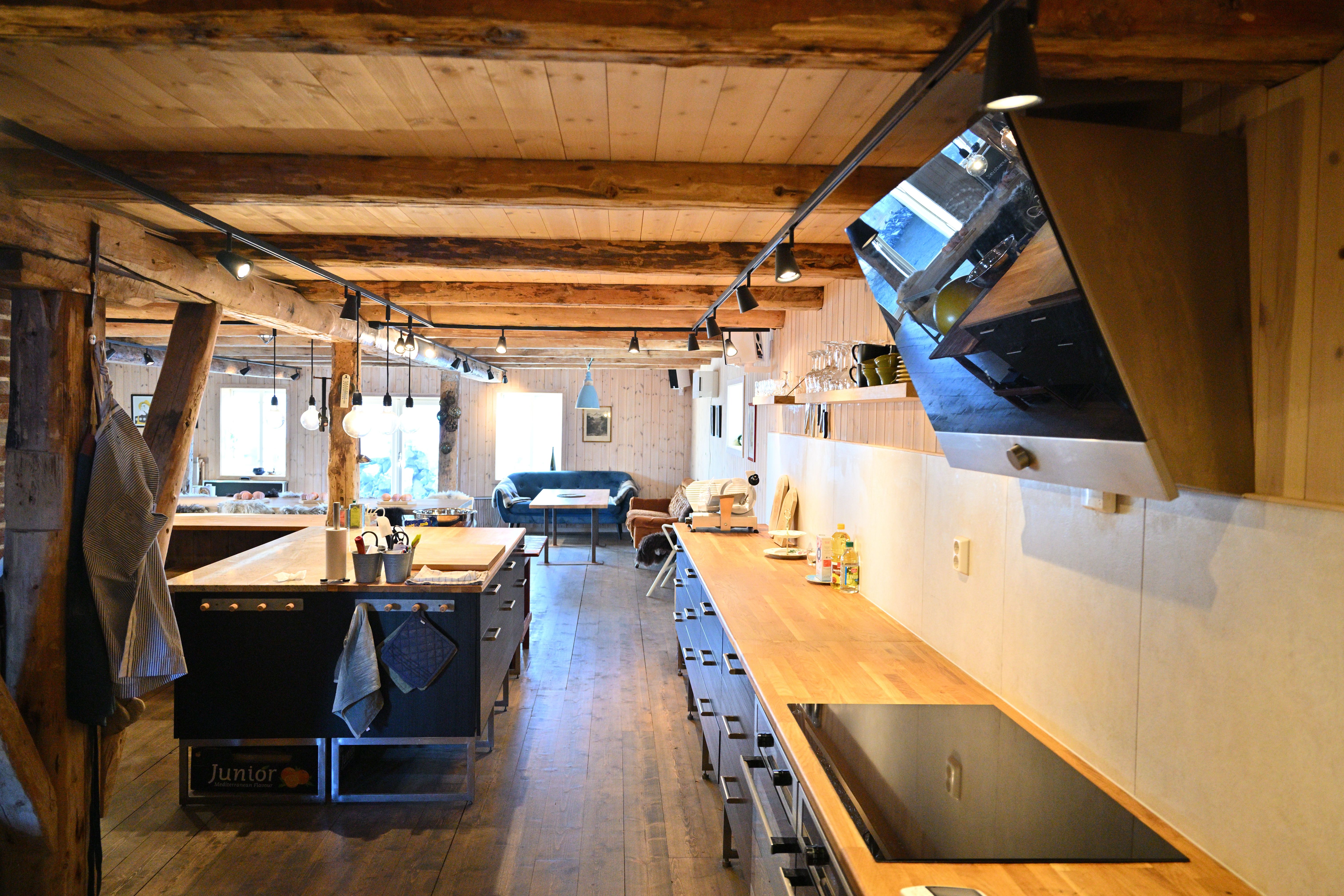 The long lodge kitchen with timber ceilings at Lofoten Pier Lodge.