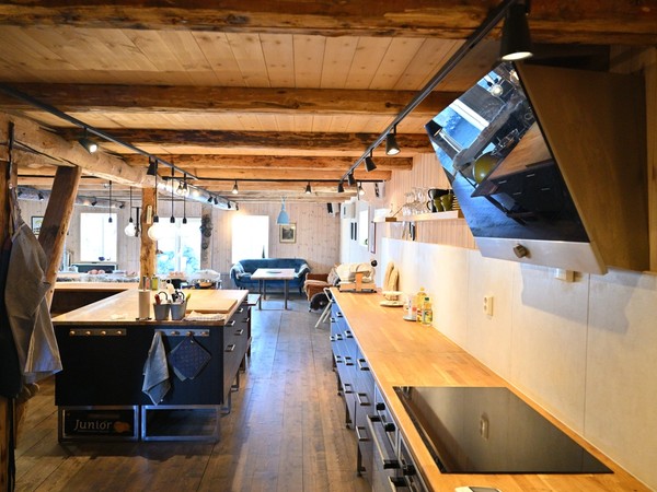 The long lodge kitchen with timber ceilings at Lofoten Pier Lodge.