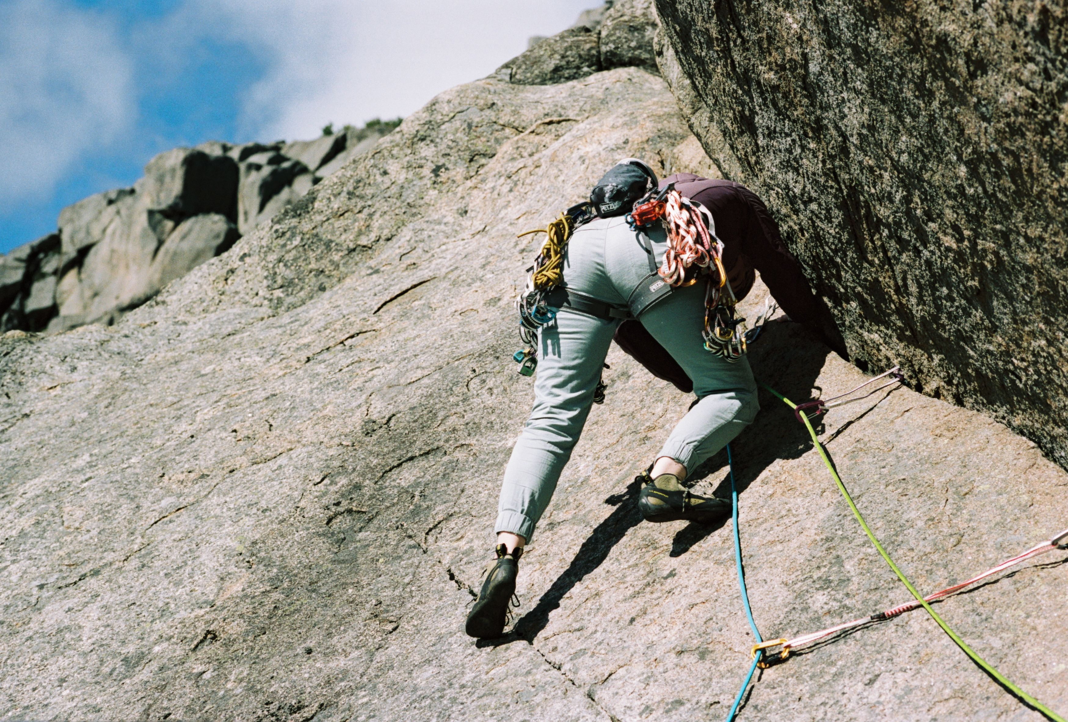 A climber going up a granite rock face