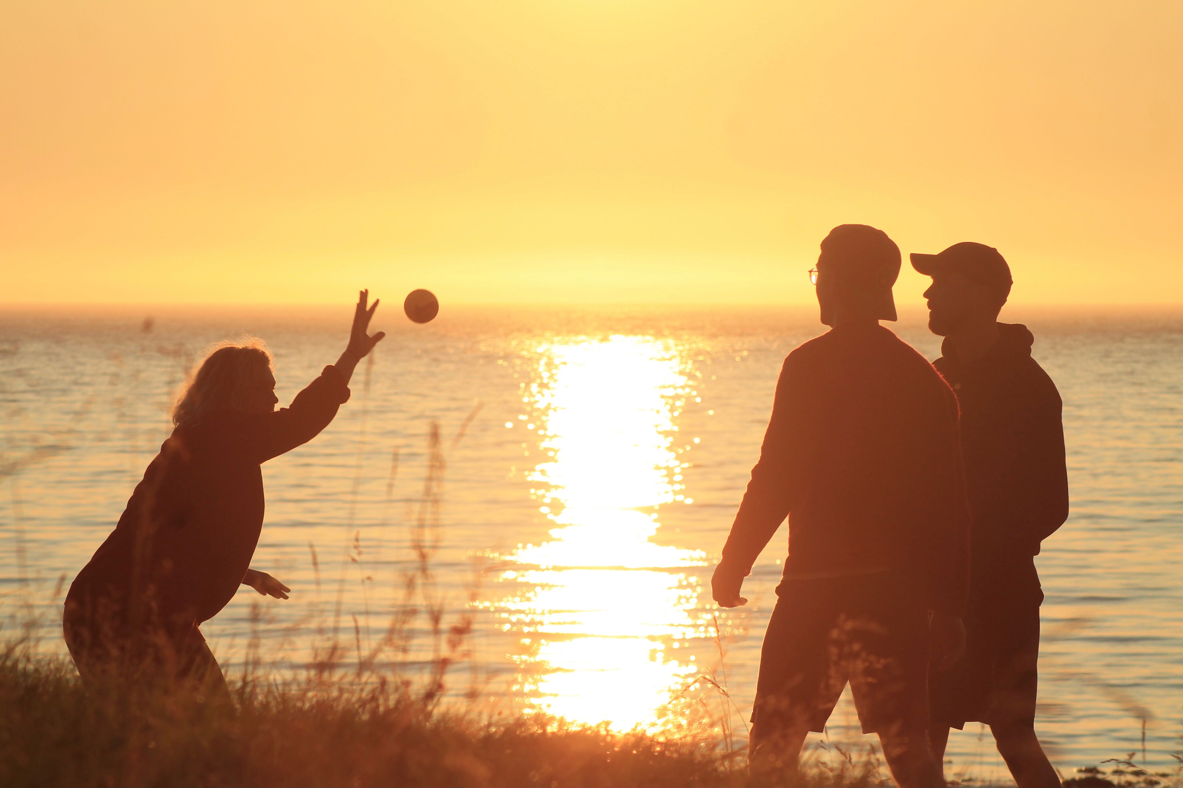 People playing Spikeball in the sunset in Norway