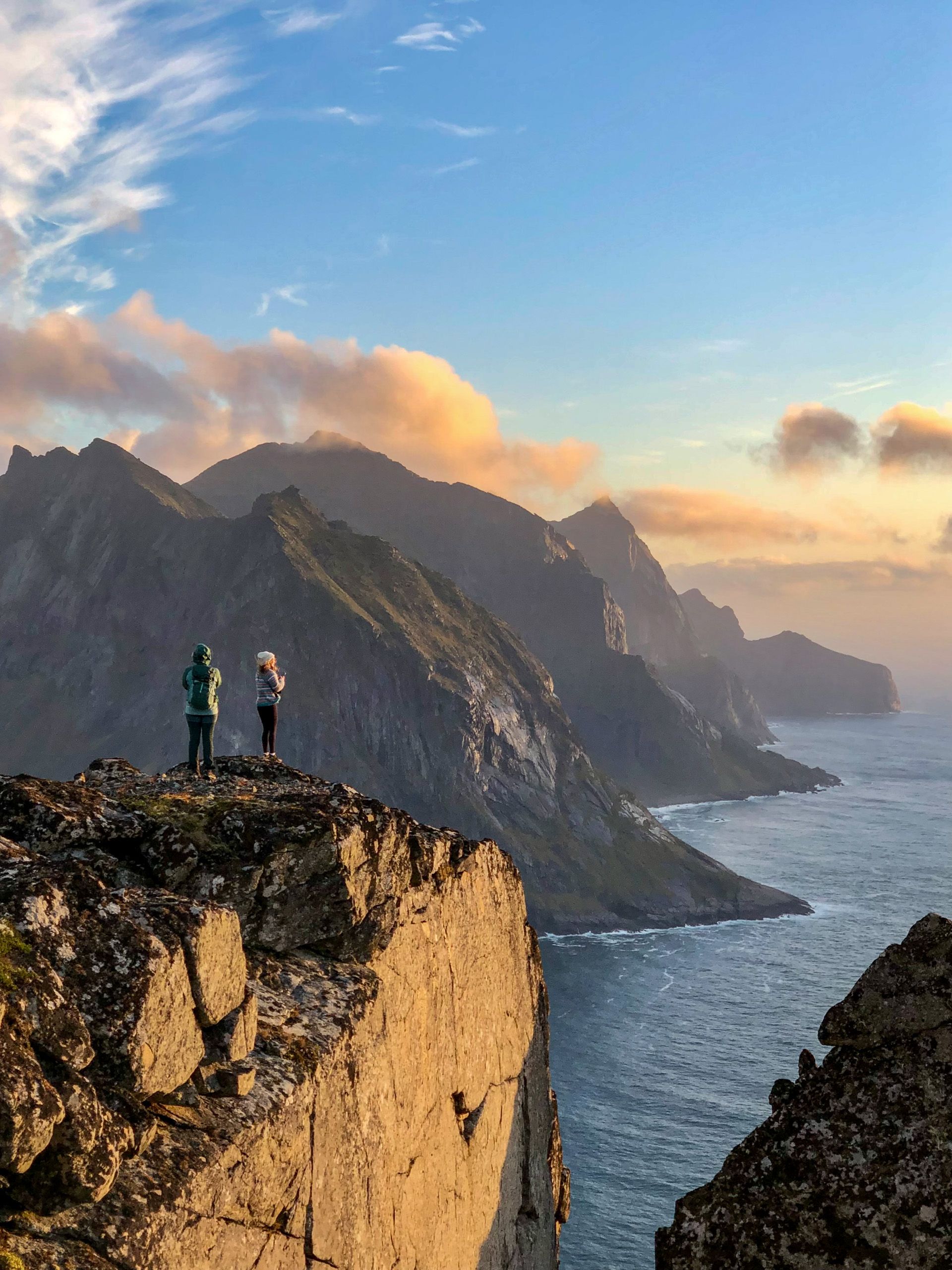 Hikers in the mountains of Lofoten at sunset