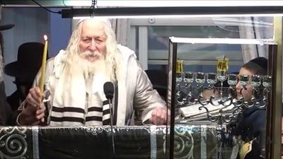 Rabbi Eliezer Berland Shlit"a Lighting Candles on First Night of Hanukah