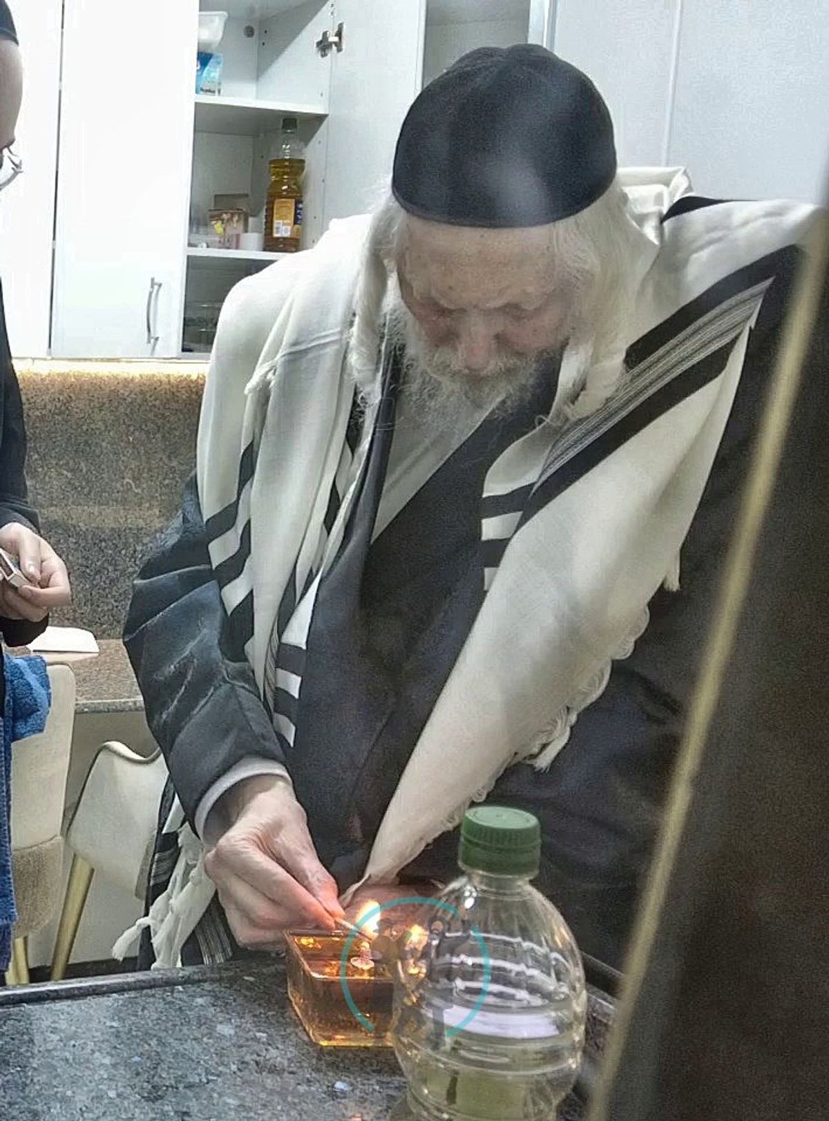 Rabbi Eliezer Berland shlit"a lighting a candle in memory of Saba Rabbi Yisrael Dov Odesser zt"l