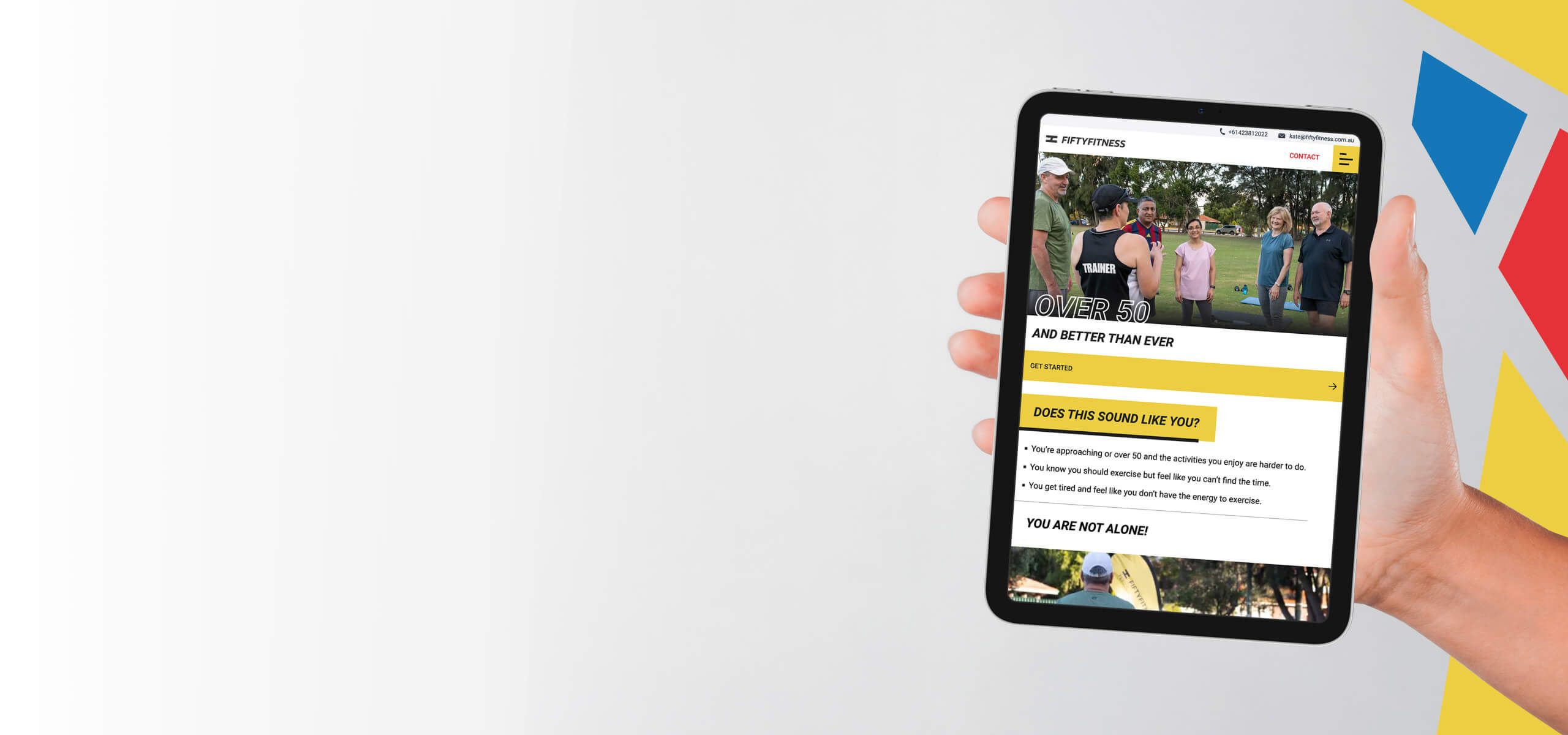 A photo of an iPad being held with the fiftyfitness website on it.