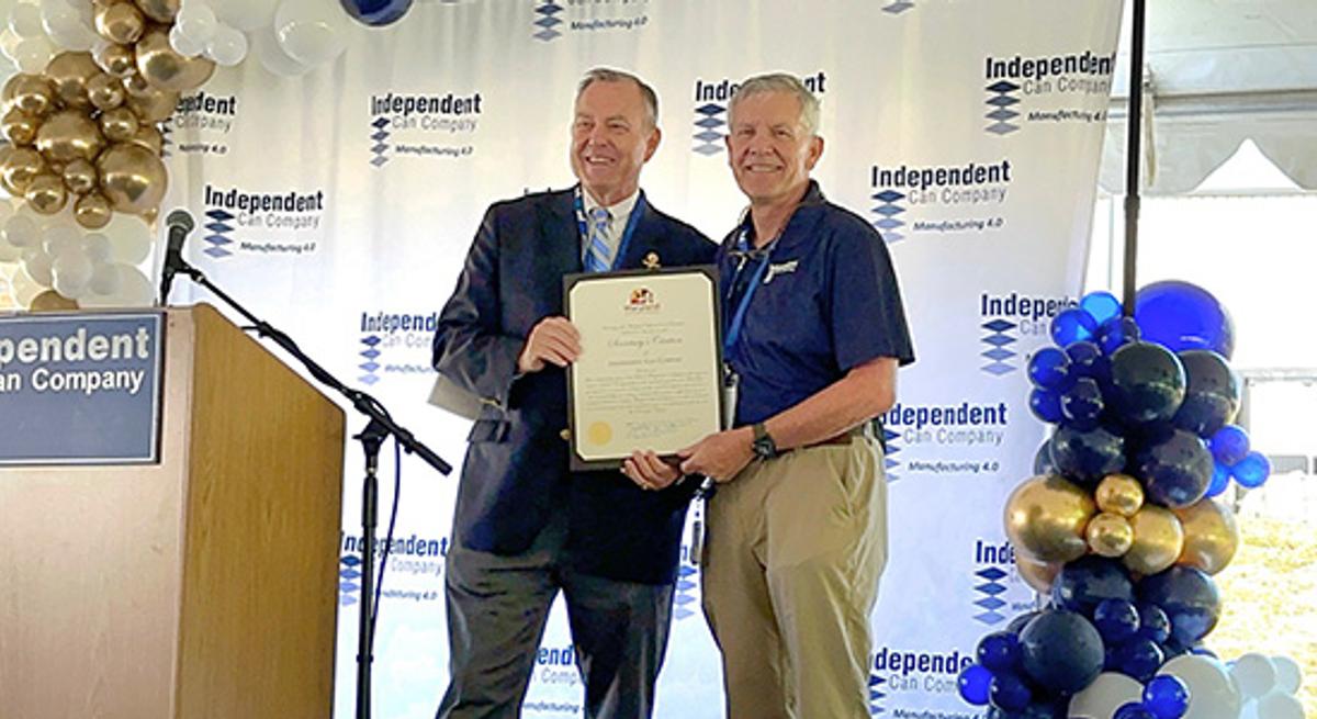 Assistant Secretary of Commerce Tom Riford (at left) presents a Secretary’s Citation to Independent Can Company President Rick Huether during the September MetalStar 3 ribbon cutting.




