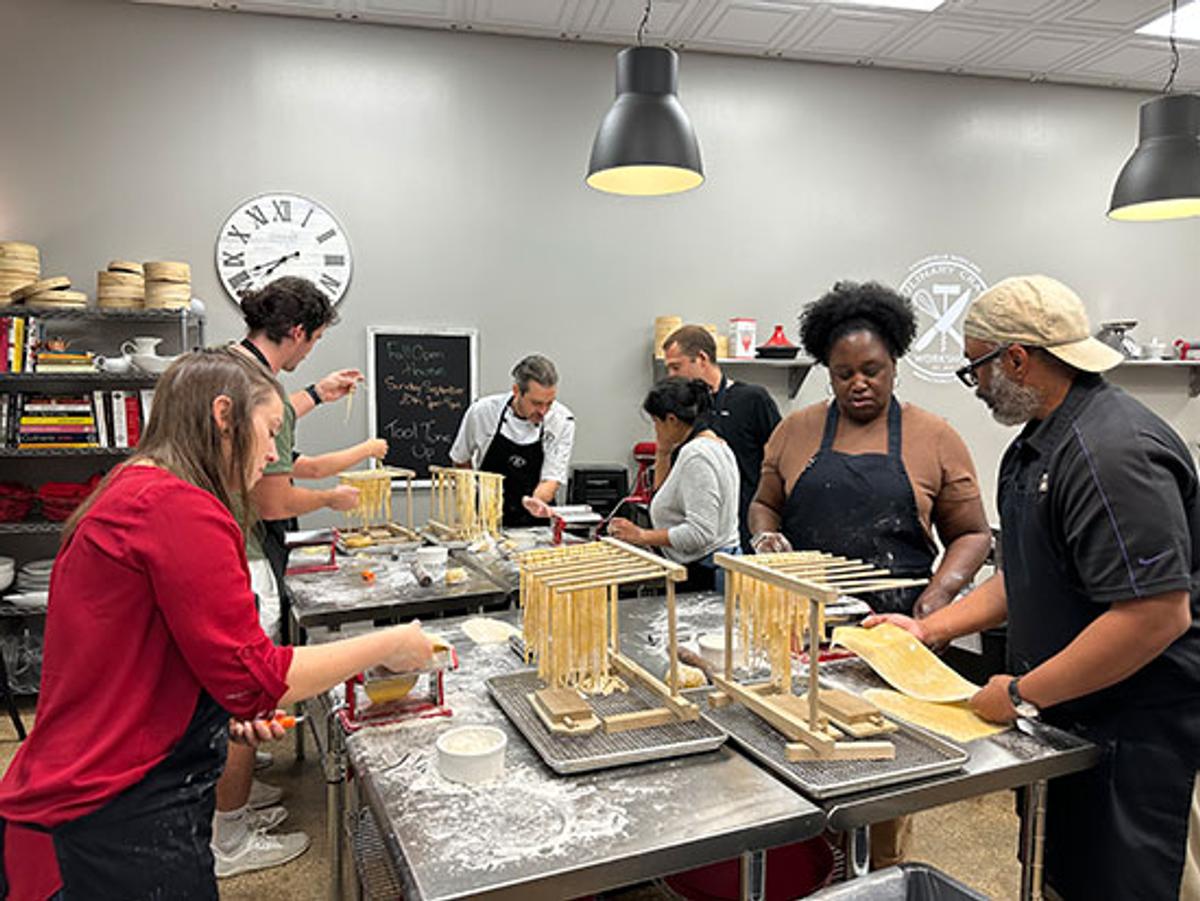 A group of people making pasta from scratch