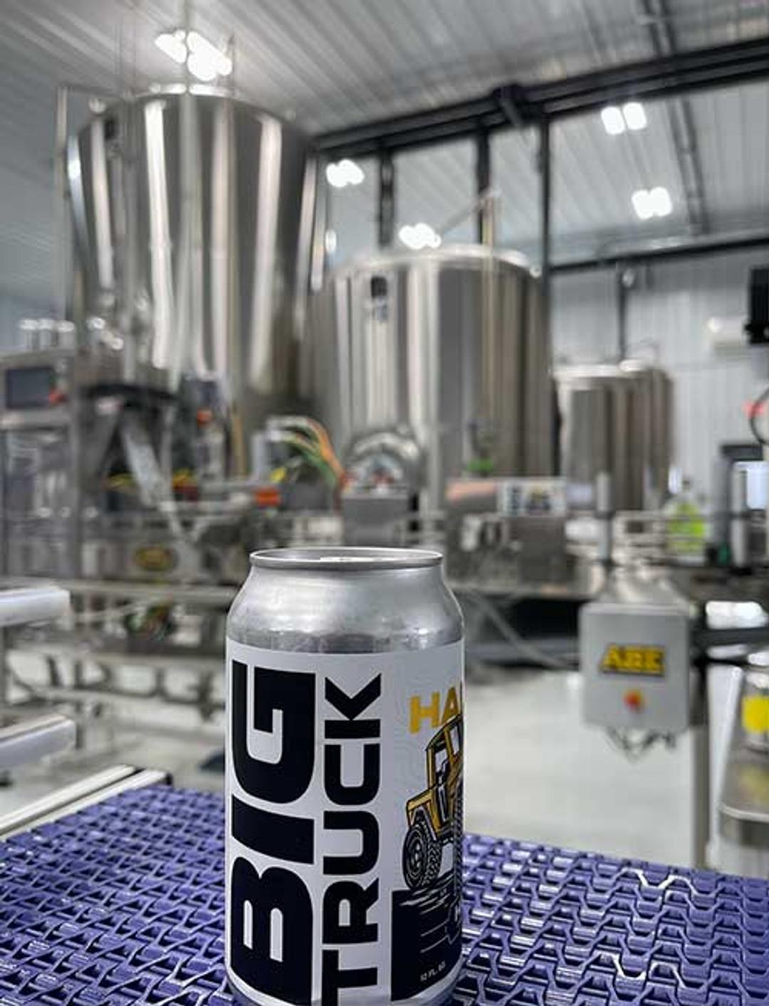 A Big Truck beer can surrounded by brewing equipment