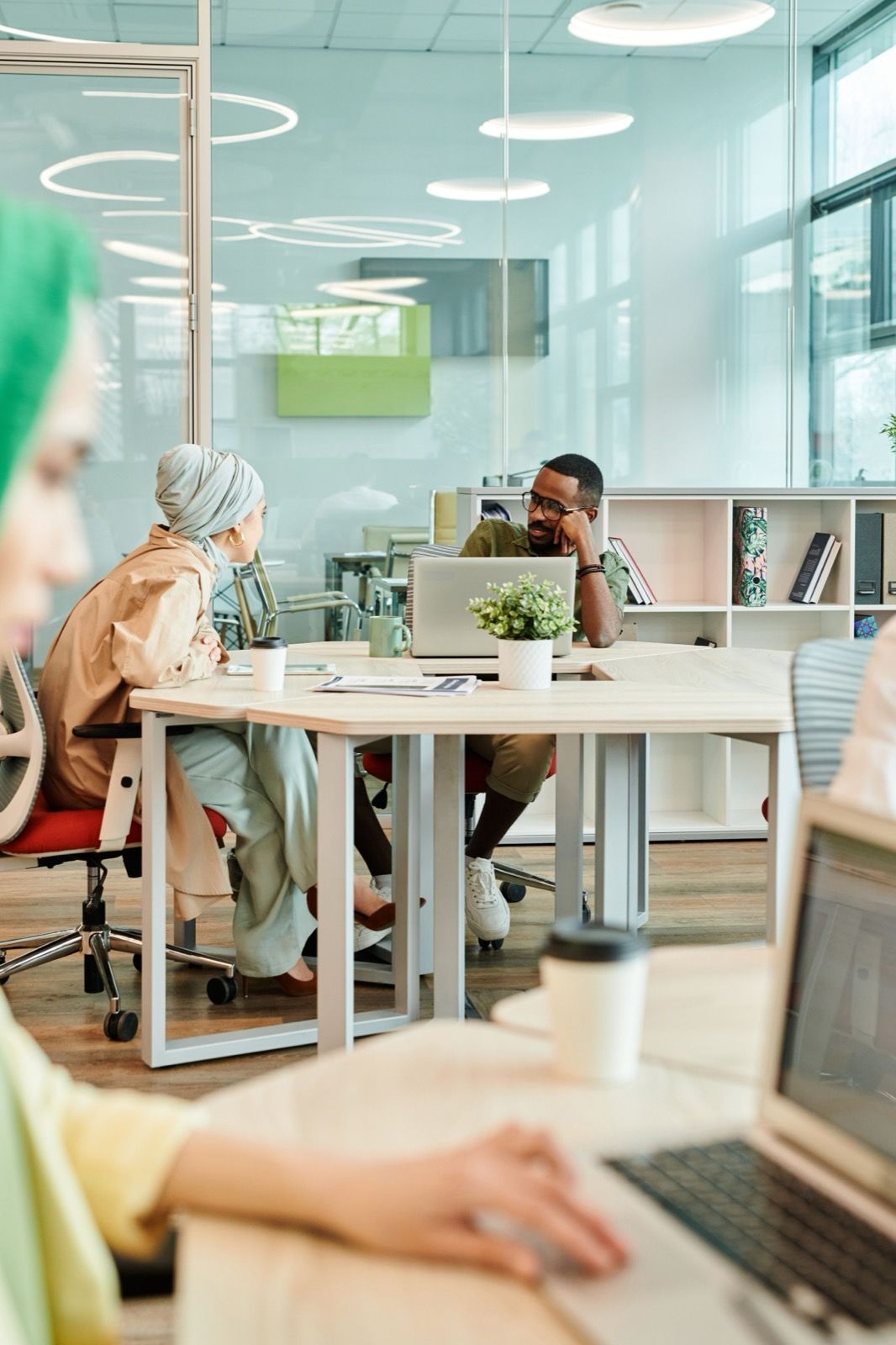 Colleagues working at shared desks in a bright office