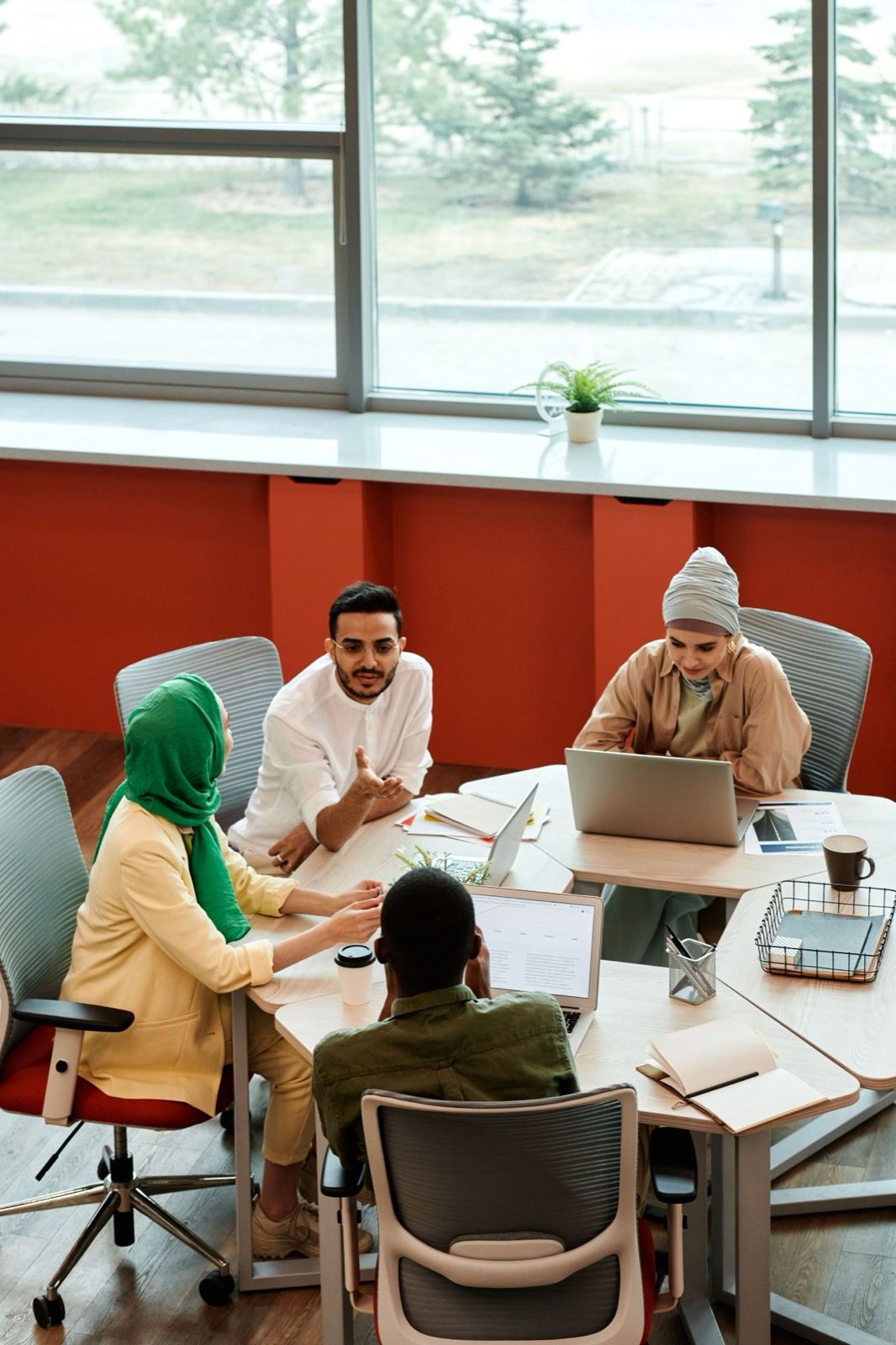 A team working together round a table with laptops
