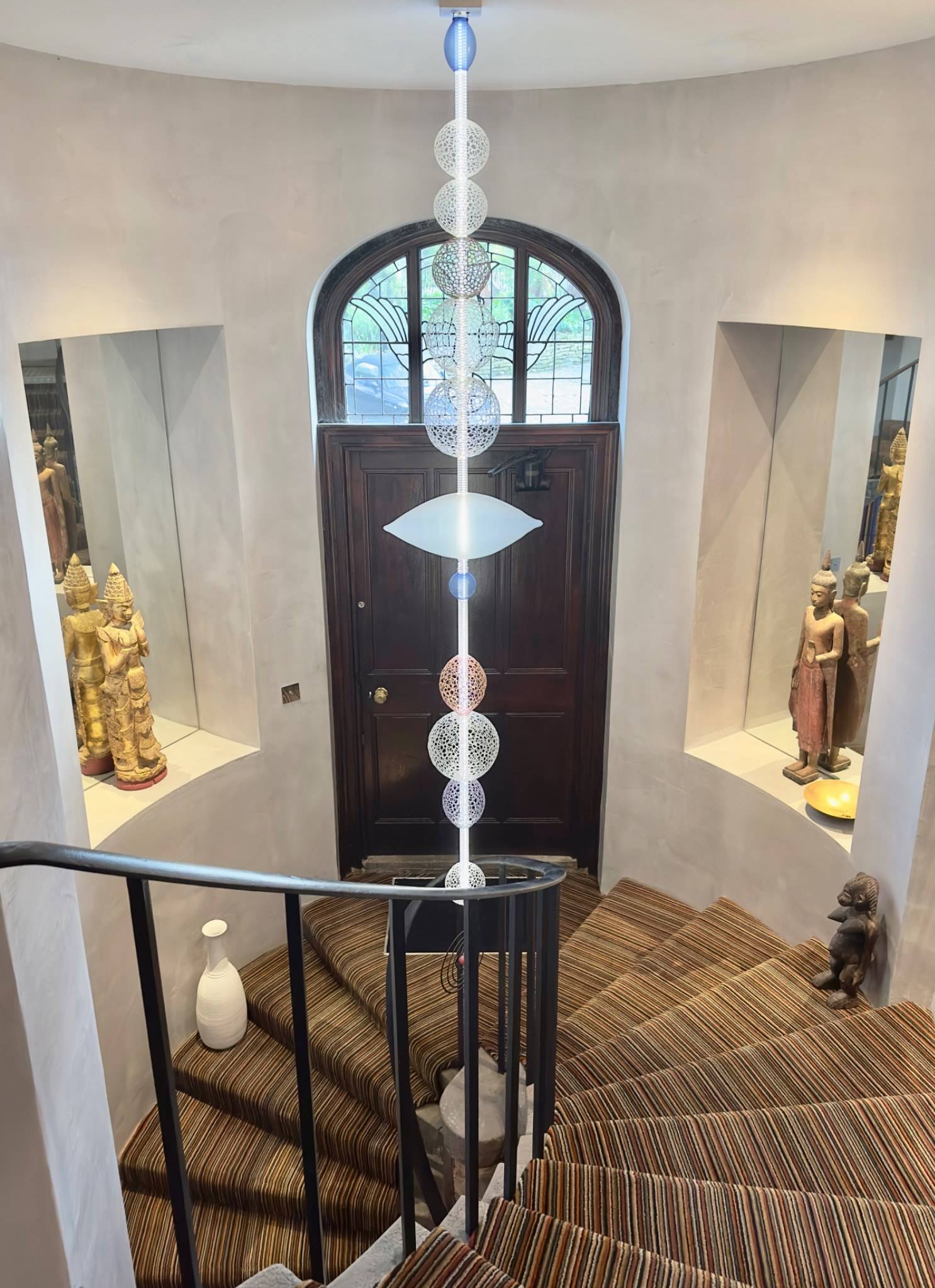 Spiral staircase and arched wooden front door entryway in a converted chapel shoot location in Oval SE5 from Love Locations.