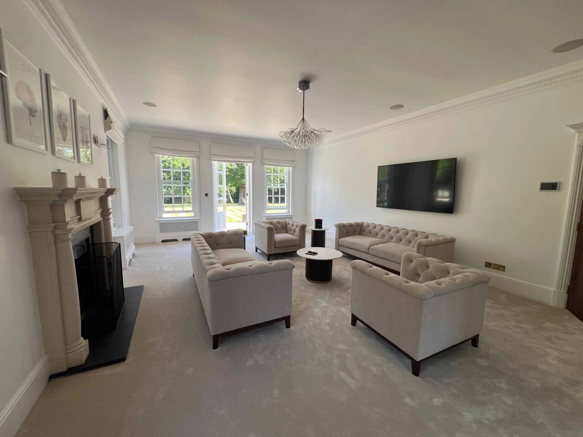 Formal sitting room featuring dark leather armchairs, sash windows, and stone fireplace surround in BR7, Love Locations.