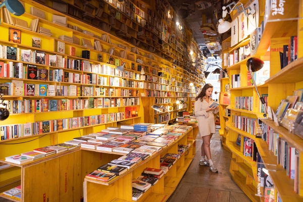 Bright bookshop with floor-to-ceiling shelves and seating area in Whitechapel London E1 – love locations