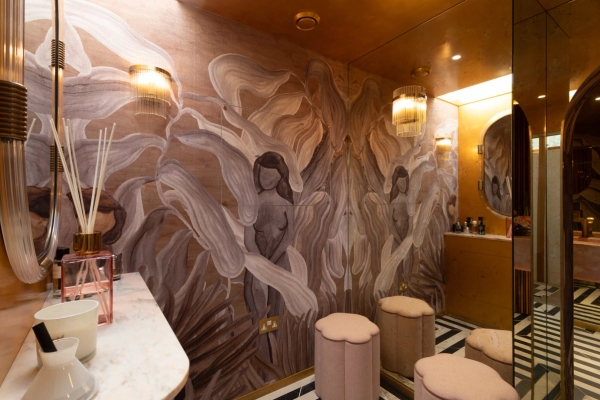 Love Locations artistic bathroom shoot space Surrey: Moody guest toilet decorated with unique figurative sketch wallpaper and brass fixtures, excellent for editorial portraiture.