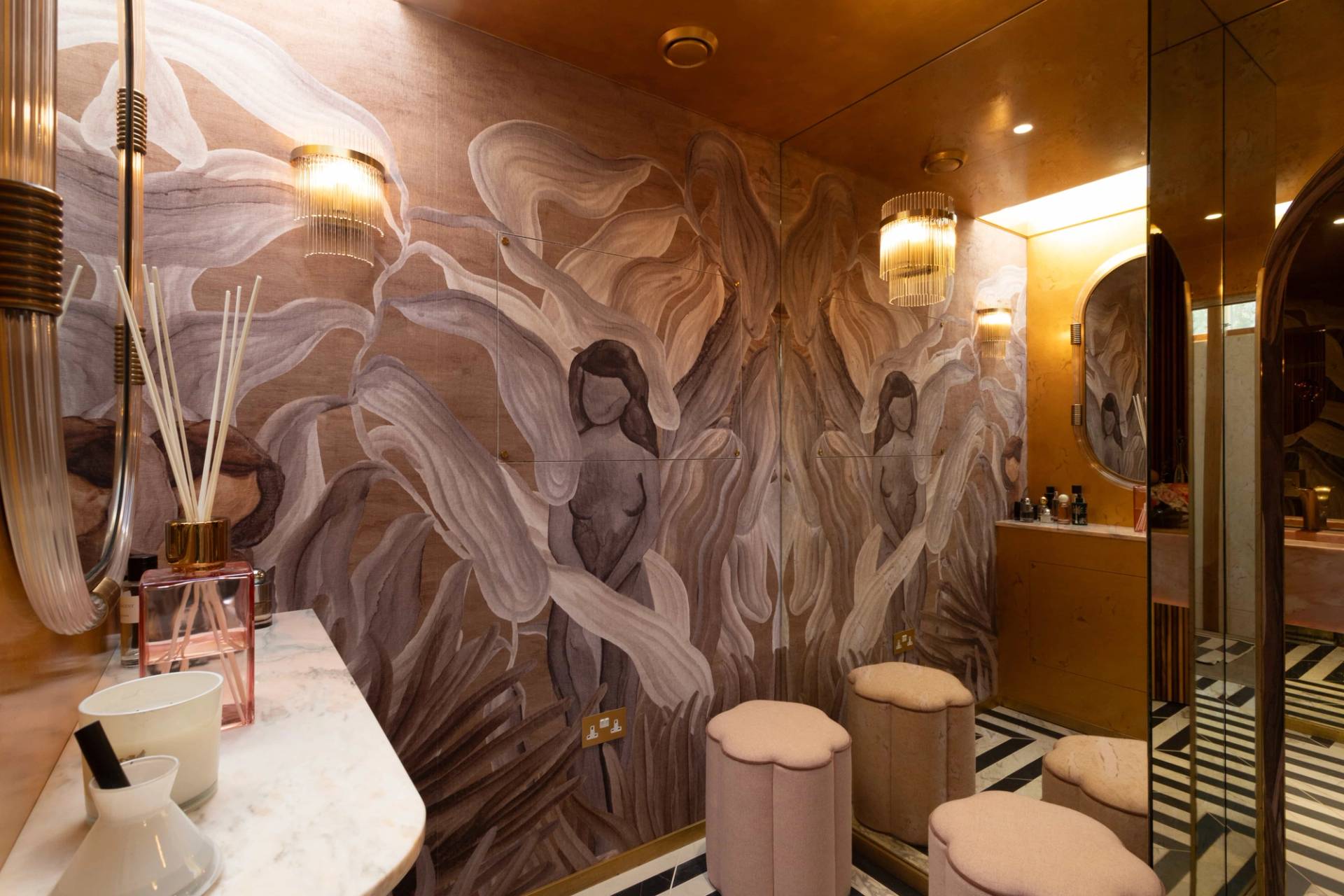 Love Locations artistic bathroom shoot space Surrey: Moody guest toilet decorated with unique figurative sketch wallpaper and brass fixtures, excellent for editorial portraiture.