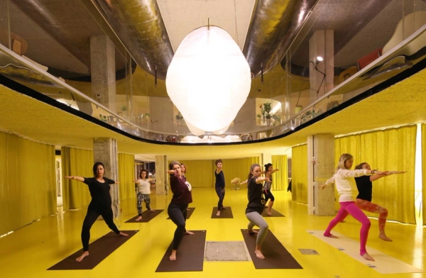 Modern Whitechapel London conference and talk venue with bright yellow interior and seating area – love locations