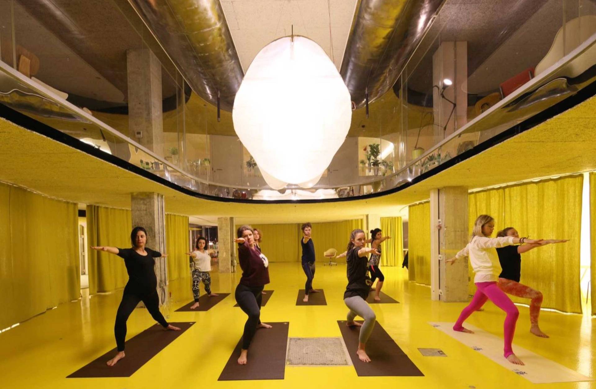 Modern Whitechapel London conference and talk venue with bright yellow interior and seating area – love locations