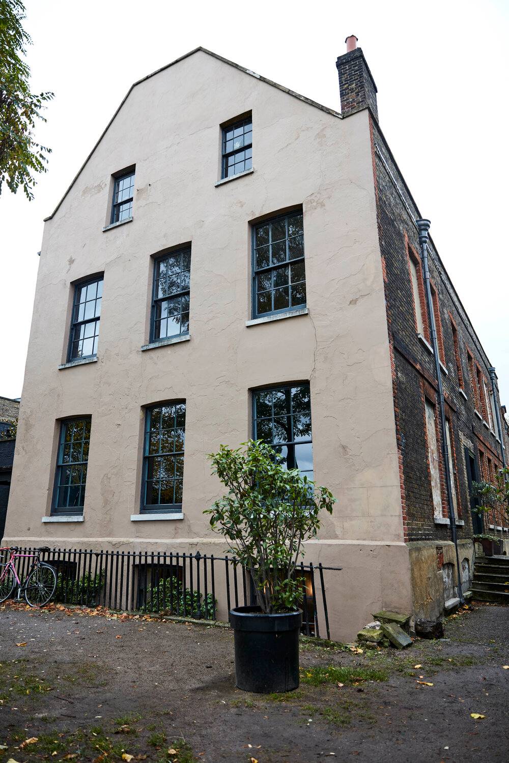 Side exterior view of a tall three-storey Georgian plaster house in Deptford, South East London, Love Locations.