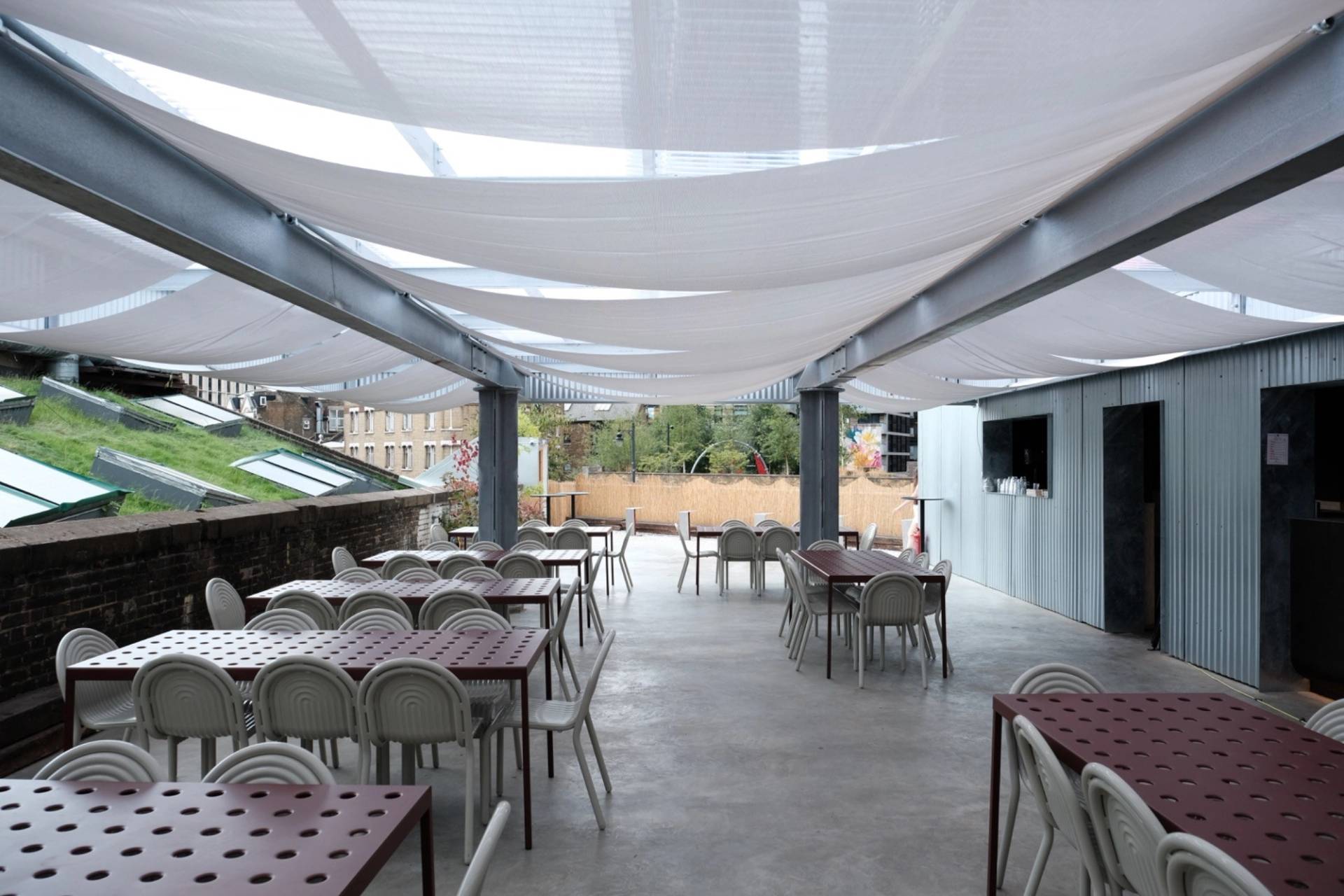 Sunlit covered rooftop patio shoot location featuring translucent canopy sails and dining setups in Hackney EC2A by Love Locations.