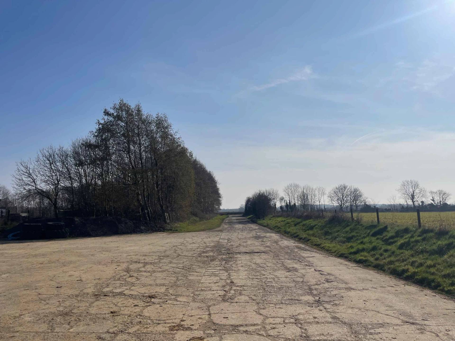 Weathered concrete estate track lined by trees, offering private vehicle access for film production units via Love Locations.
