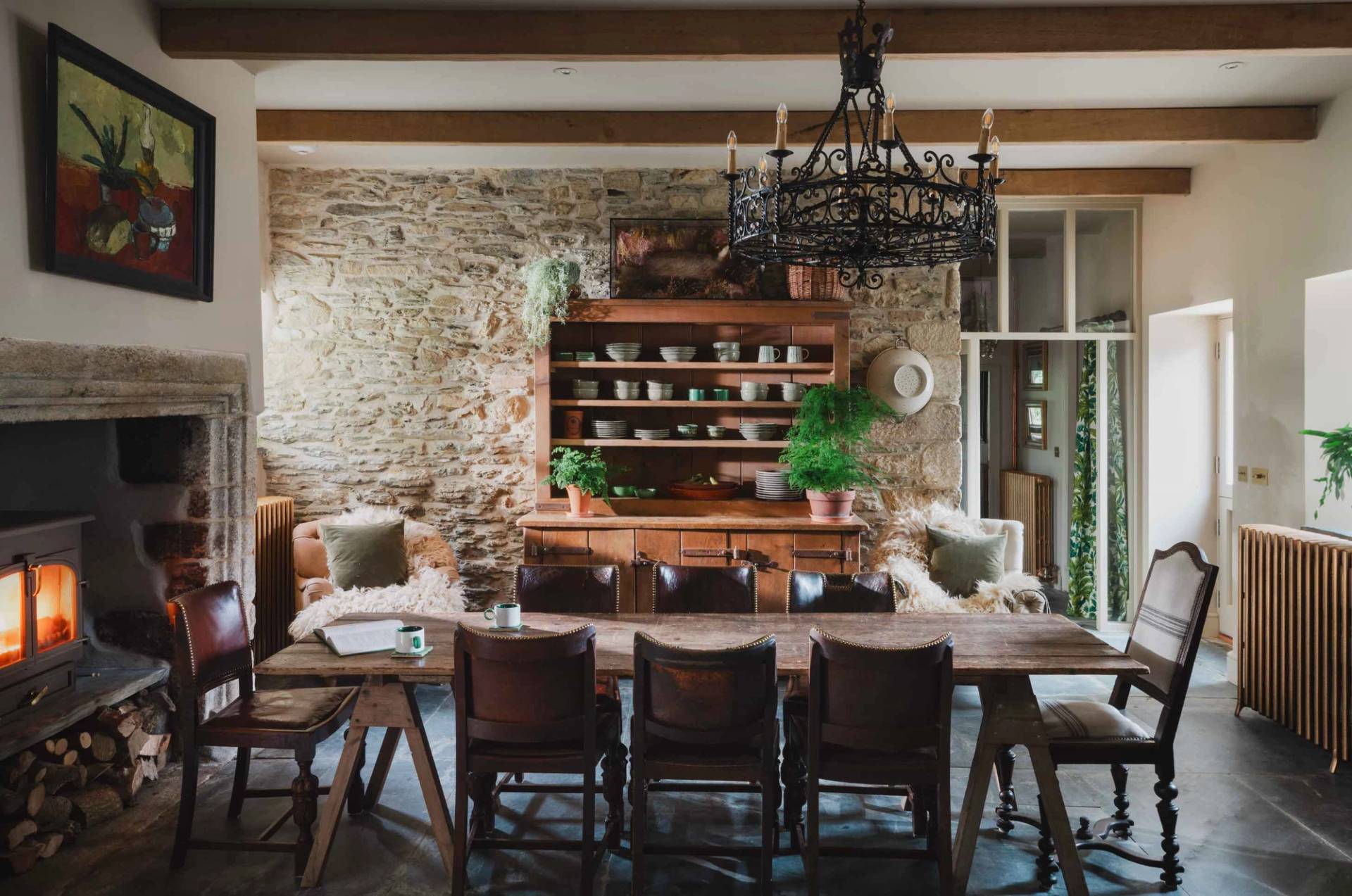 Characterful farmhouse dining hall photoshoot venue in Newquay Cornwall through Love Locations, featuring an antique wooden dresser, exposed stone walls, and timber ceiling beams.