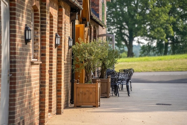 Classic English country house architecture with outdoor seating area, available for commercial venue hire through Love Locations.