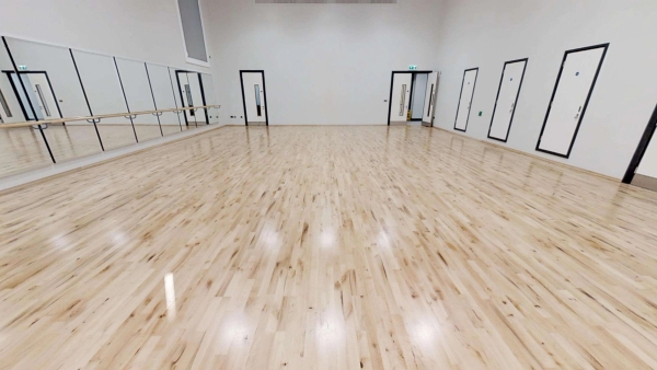 Bright, modern drama studio or rehearsal space with premium light wood floors for commercial video shoots, Love Locations.