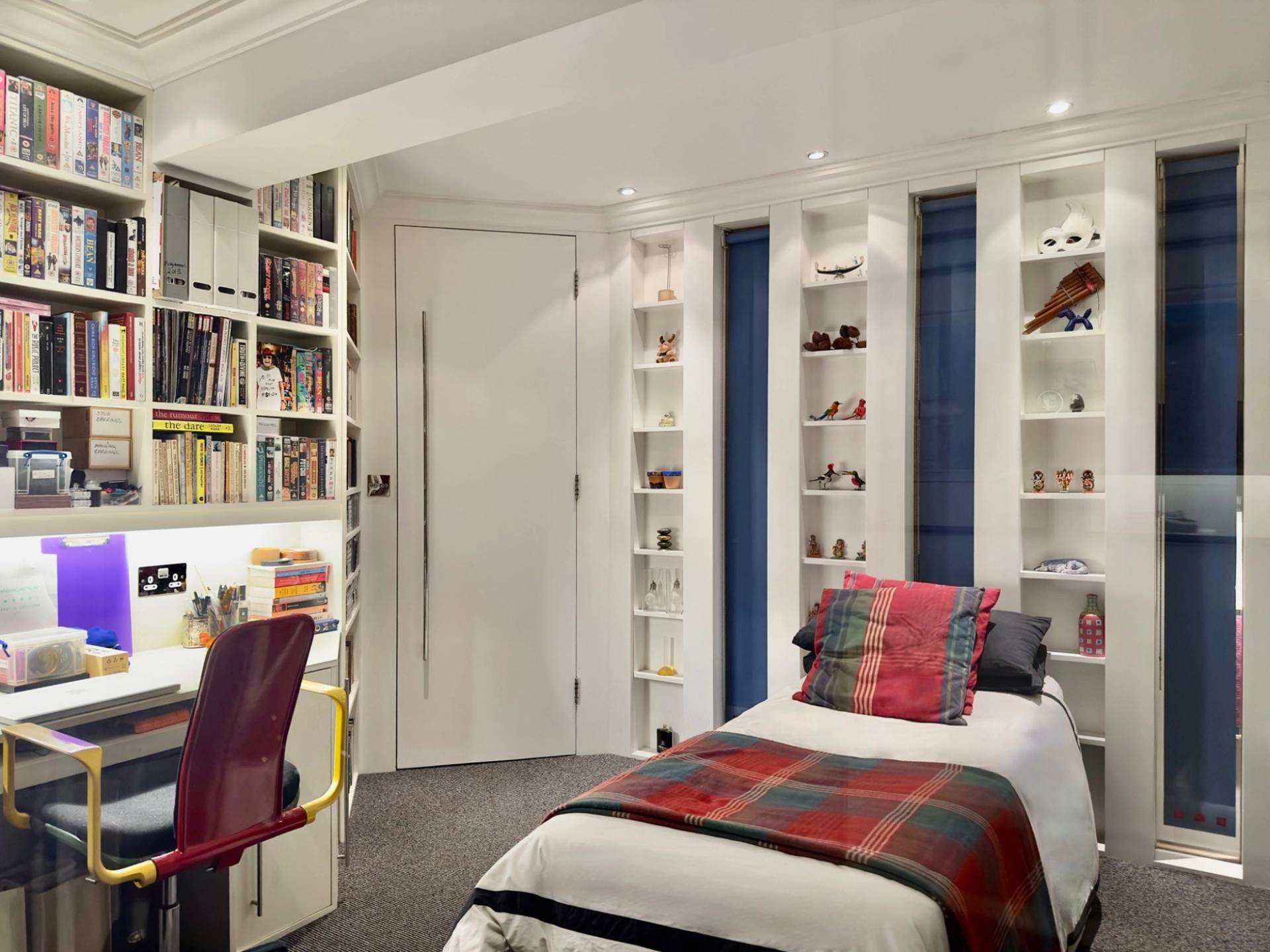 Study or home office space under a sloped attic ceiling with built-in bookshelves in a London shoot location in Oval SE5 through Love Locations.